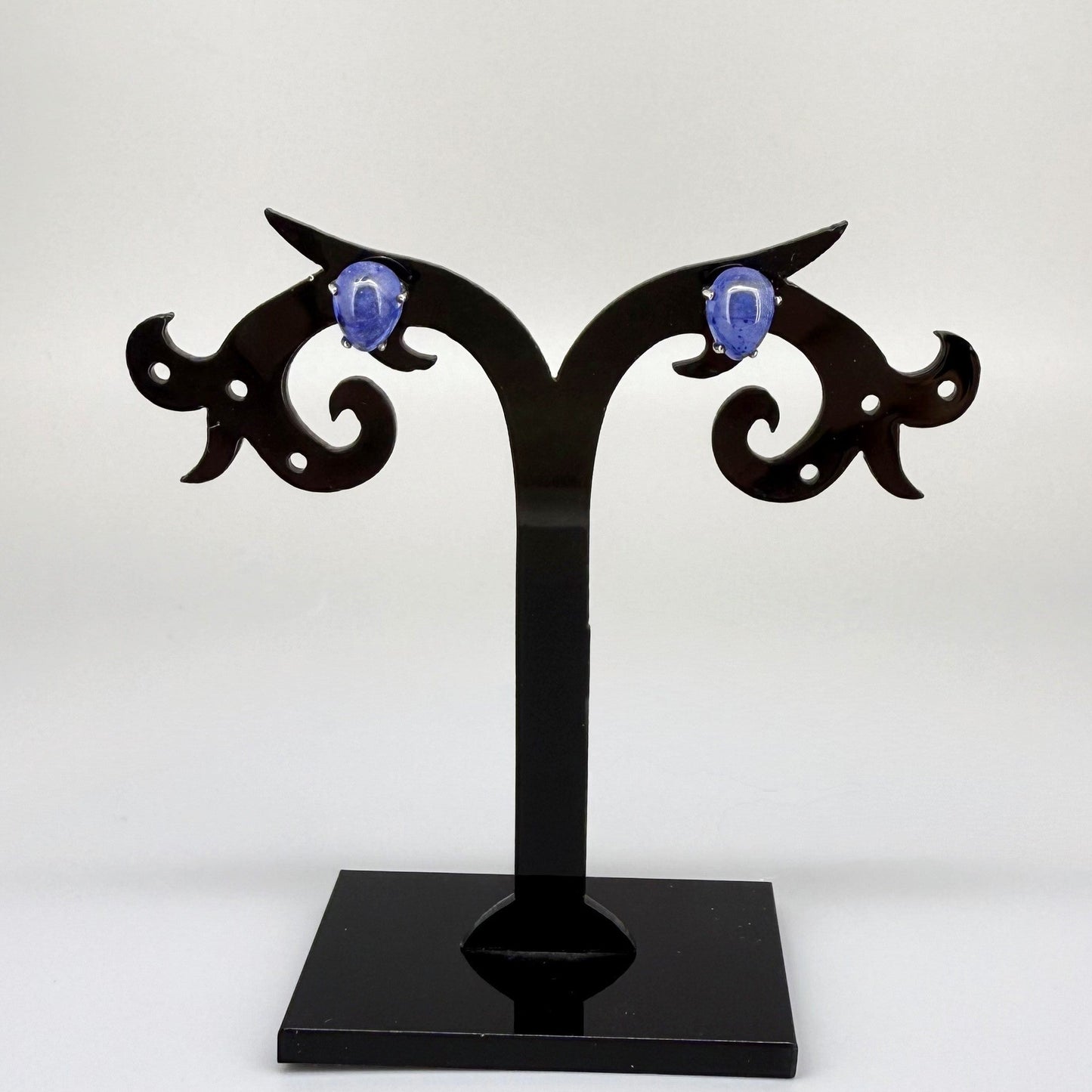 Sterling silver stud earrings with deep blue natural sapphires, plated in white gold for refined brilliance.