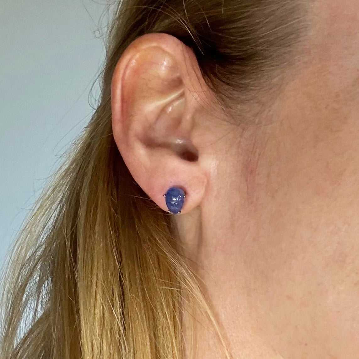 Sterling silver stud earrings with deep blue natural sapphires, plated in white gold for refined brilliance.