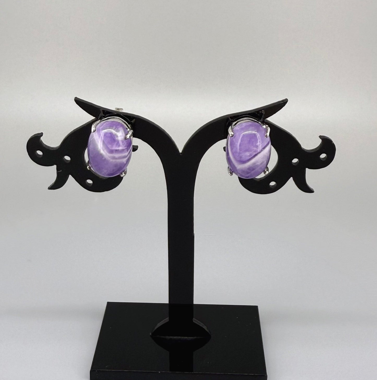 Natural amethyst stud earrings in white gold plated sterling silver with butterfly backs.