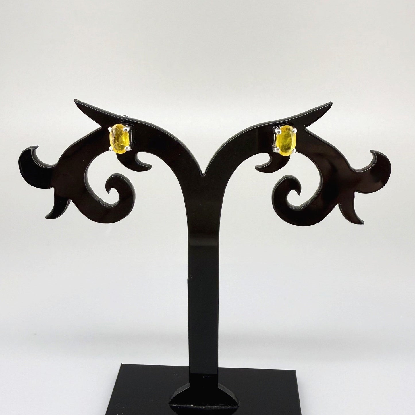 Natural yellow sapphire stud earrings in white gold plated sterling silver with butterfly backs.