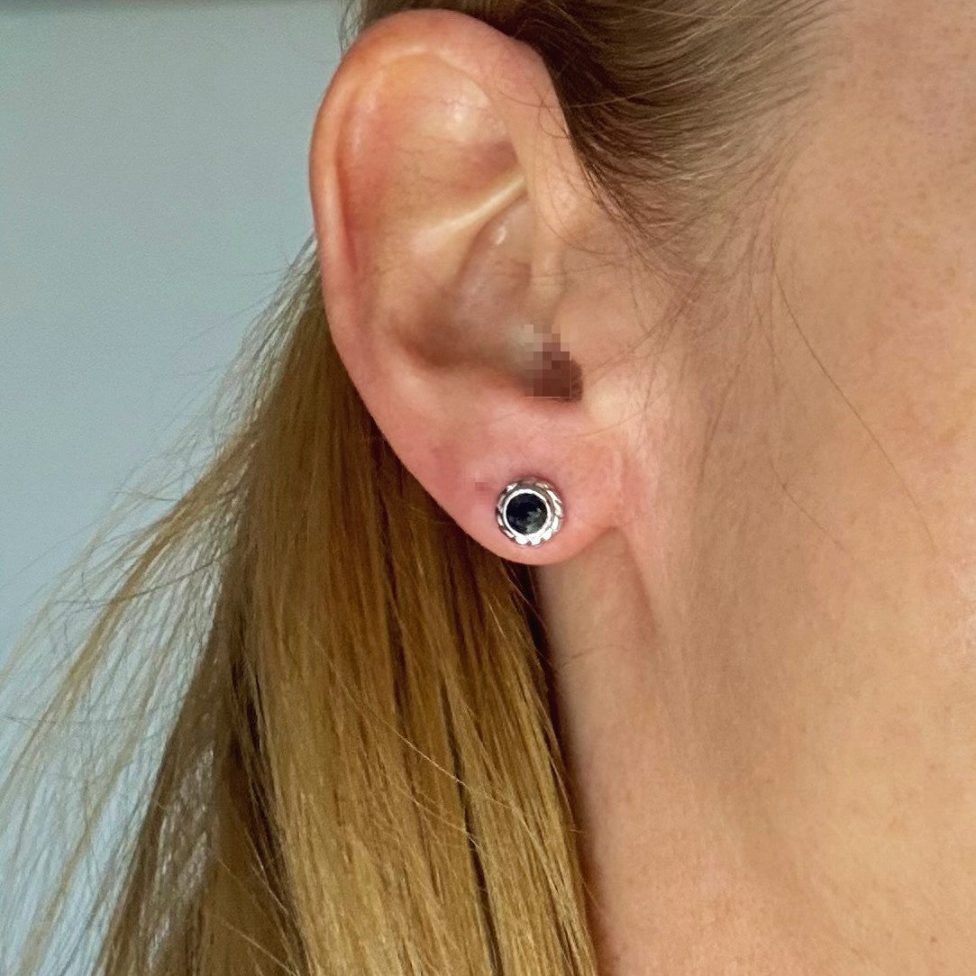 Blue sapphire stud earrings in white gold plated sterling silver with round floral backs.