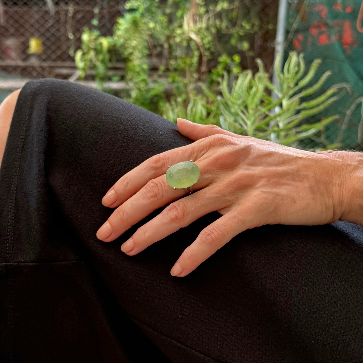 Chrysoprase ring in white gold plated sterling silver featuring an oval cabochon gemstone with light apple-green hue and smooth, natural translucence.