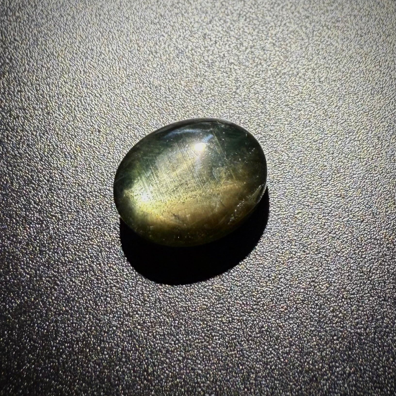 Golden-brown star sapphire cabochon, natural gemstone with subtle asterism