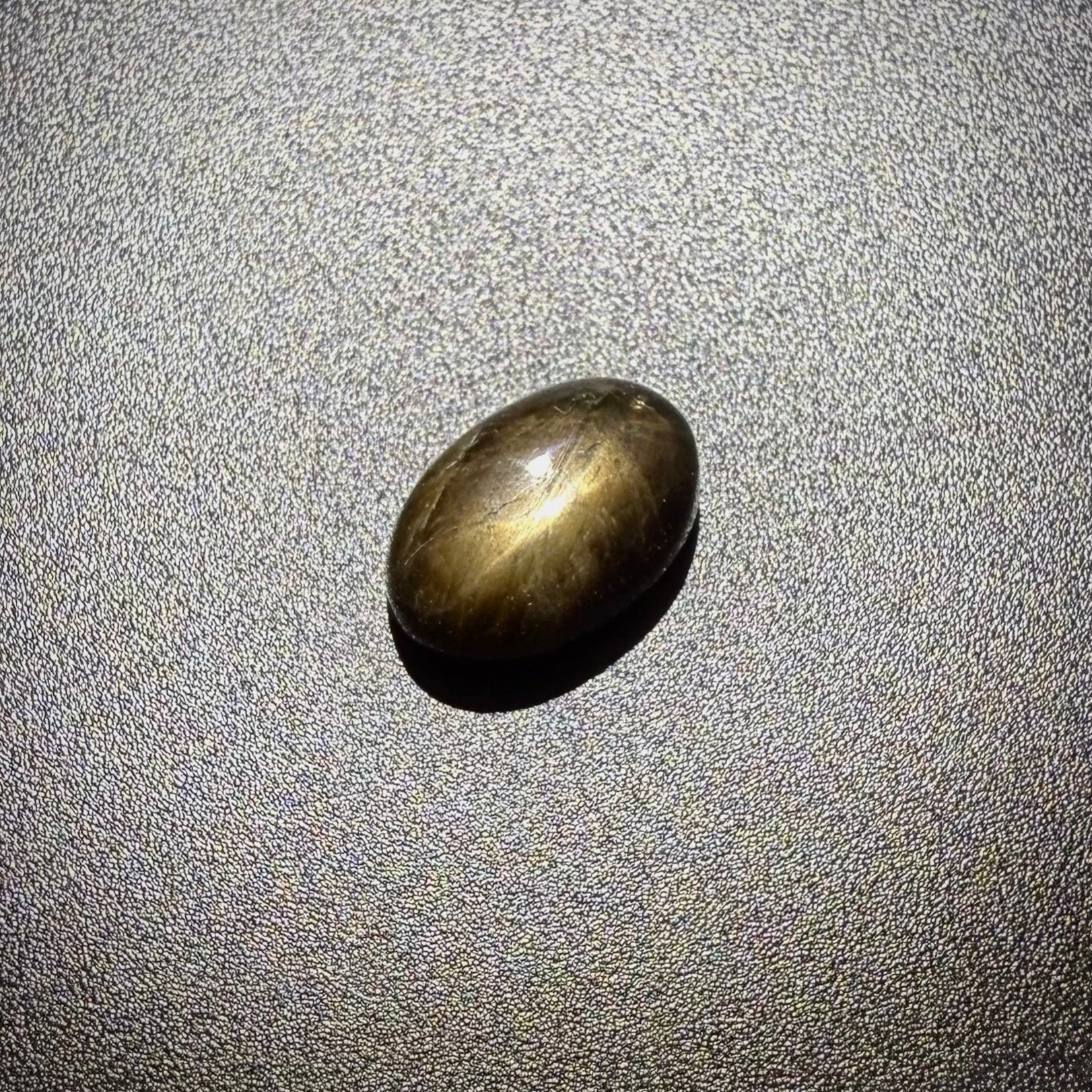 Golden-brown star sapphire cabochon, natural gemstone with subtle asterism