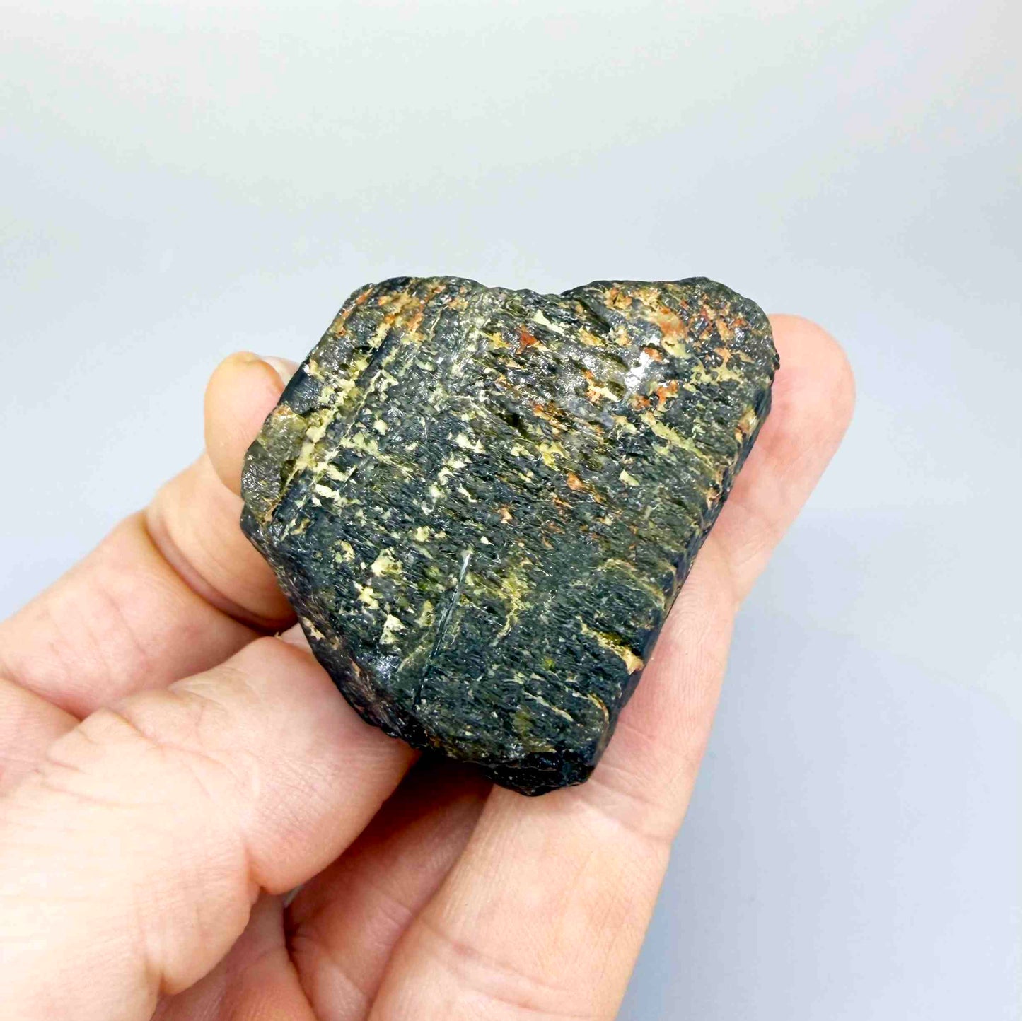 Untreated yellow sapphire rough (corundum) in warm yellow-orange hues, uncut natural gemstone.