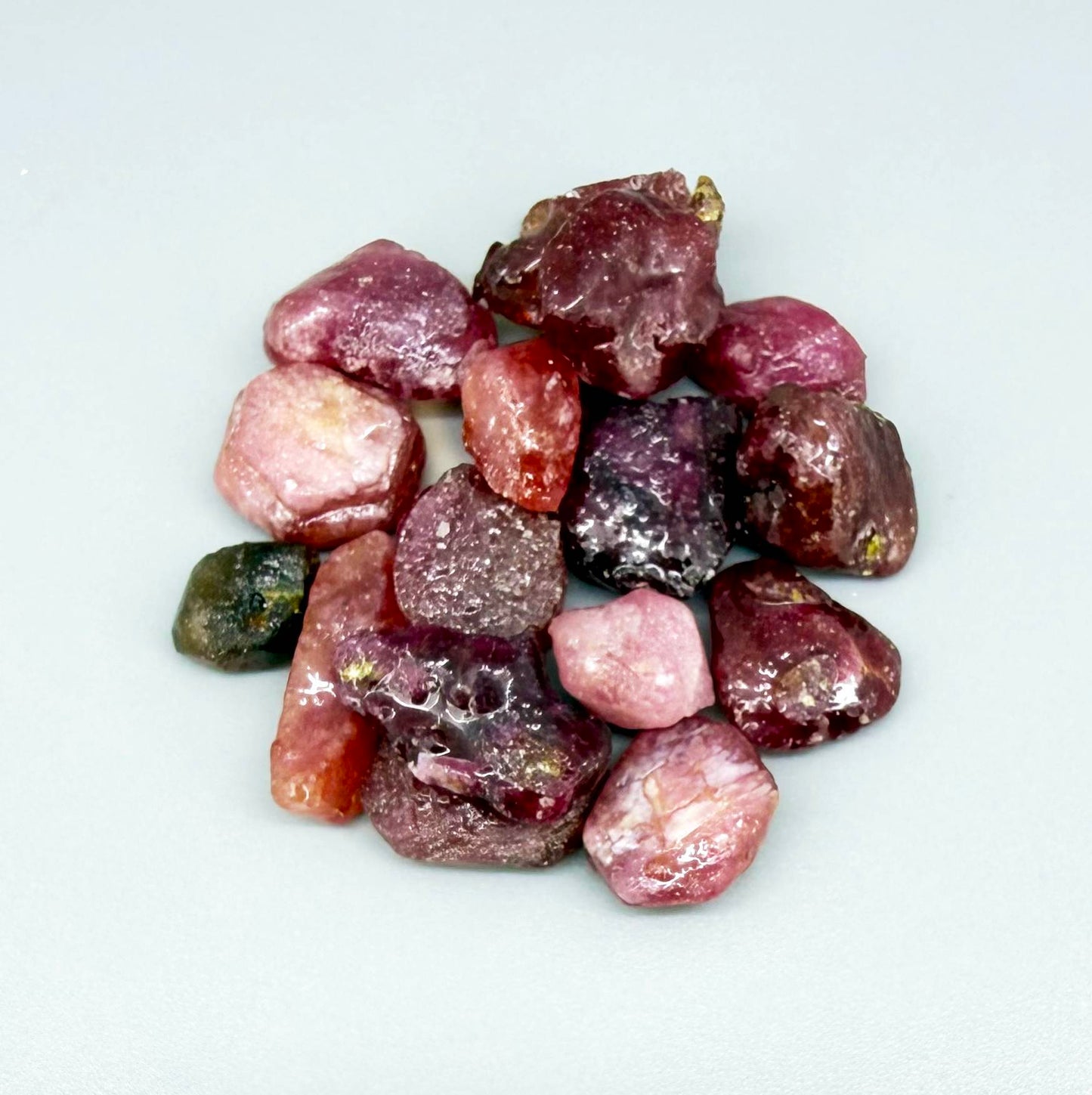 Ruby rough (Corundum) in vibrant red hues, treated and lightly oiled, small curated lot.