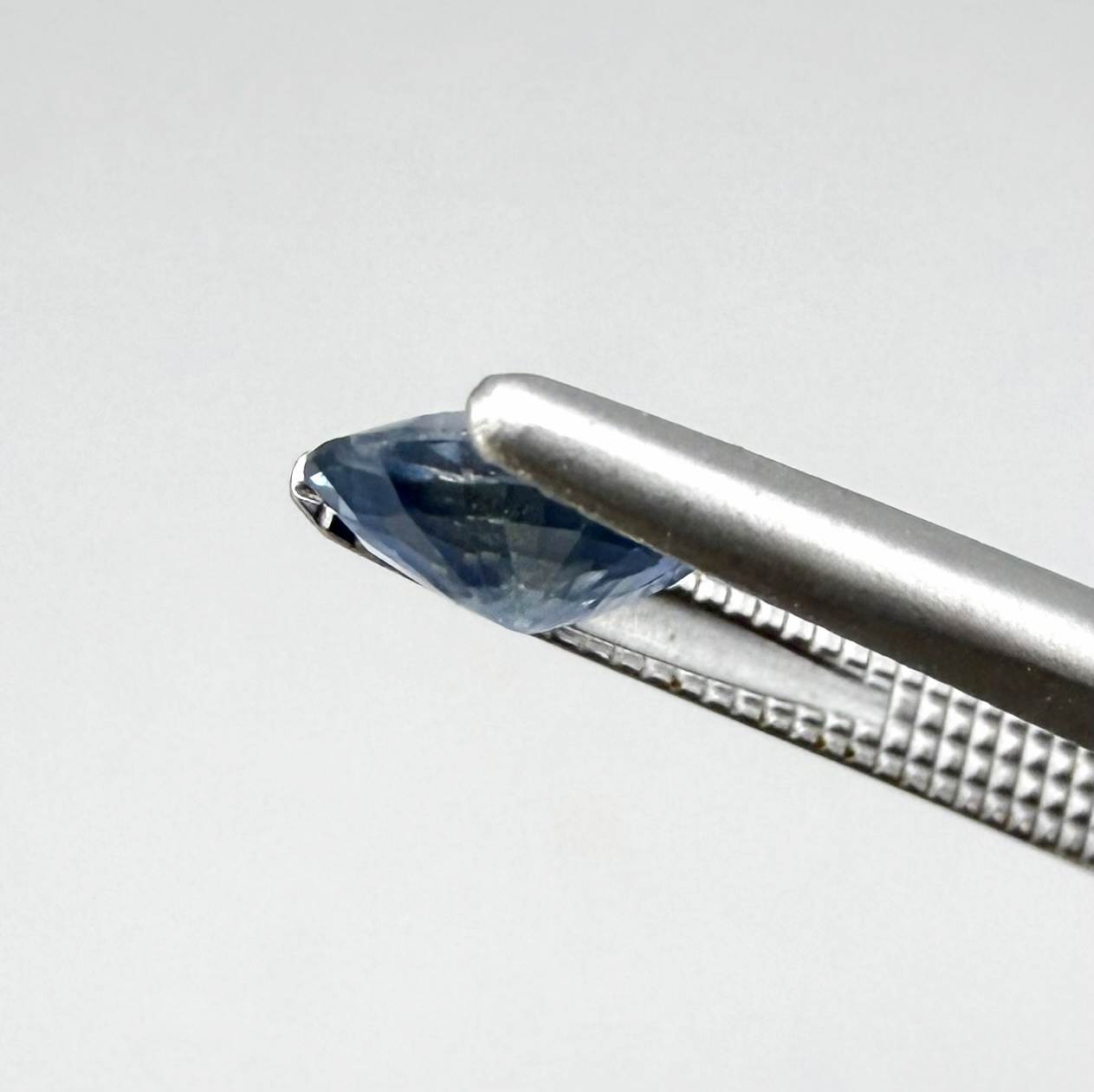 Oval soft medium blue sapphire from Bangkaja, Thailand, unheated, with natural color zoning and soft silky blue tone.