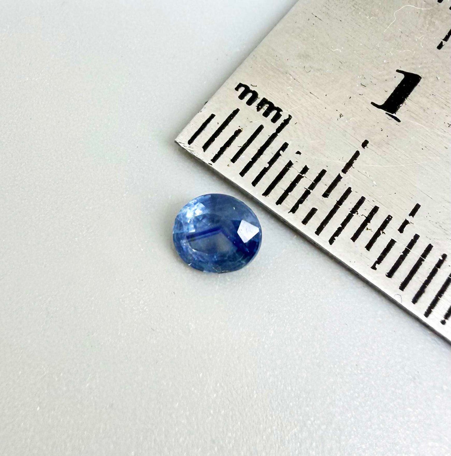 Oval medium steel blue sapphire from Bangkaja, Thailand, unheated, with natural color zoning and lively brilliance.