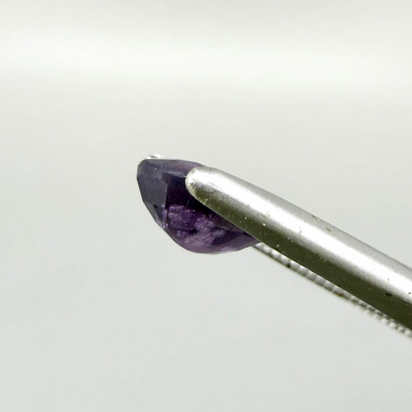 Oval-cut rich purple sapphire from Thailand, natural faceted gemstone suitable for fine jewelry.