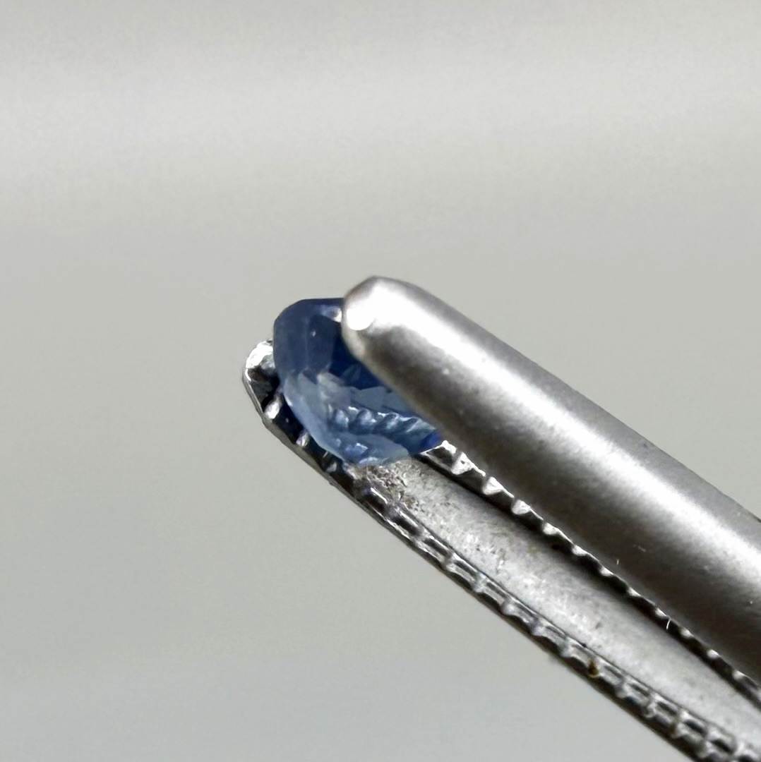 Round soft medium blue sapphire from Bangkaja, Thailand with natural color zoning and gentle silky blue tone.