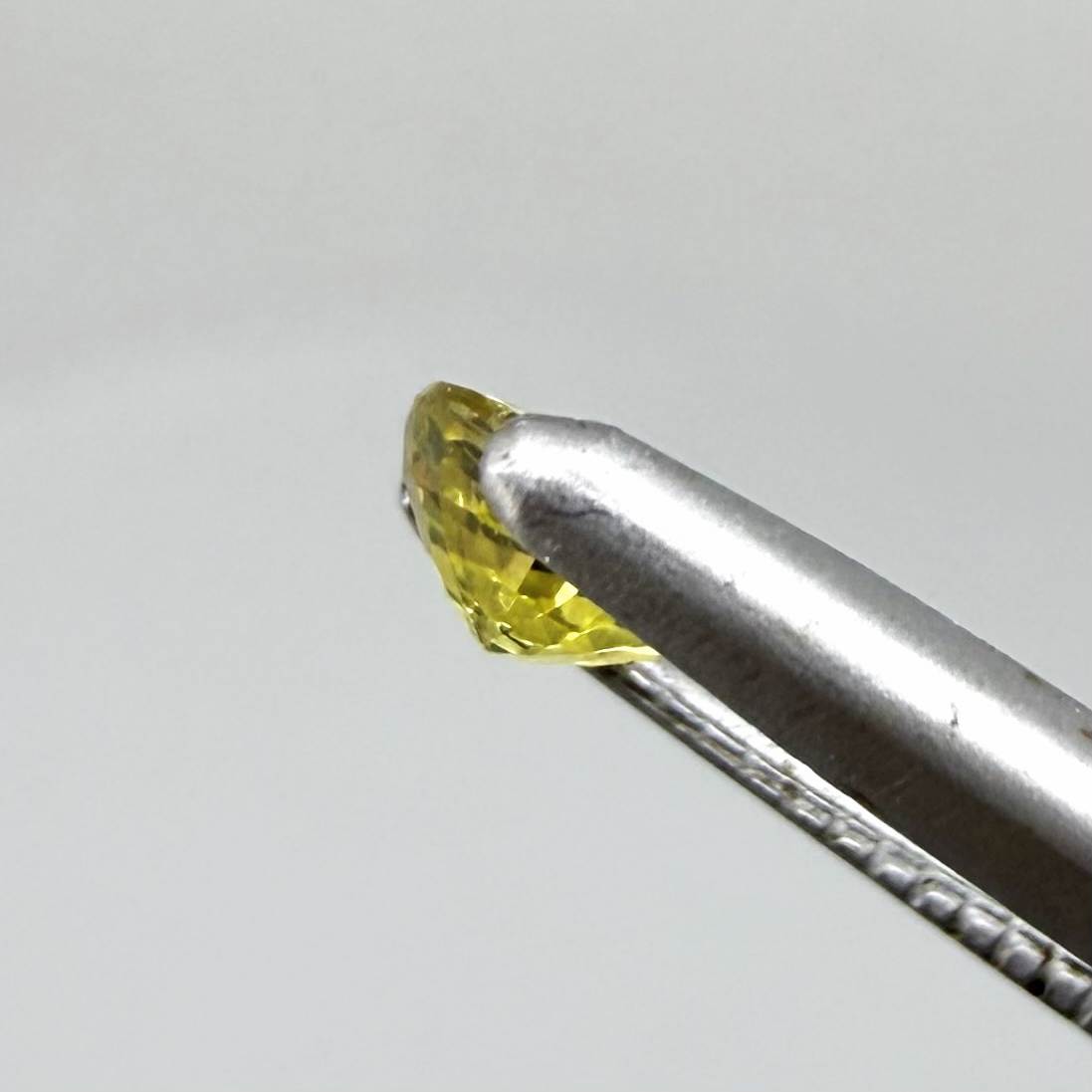 Round lemon yellow sapphire from Bangkaja, Thailand with vivid bright color and clean, lively brilliance.