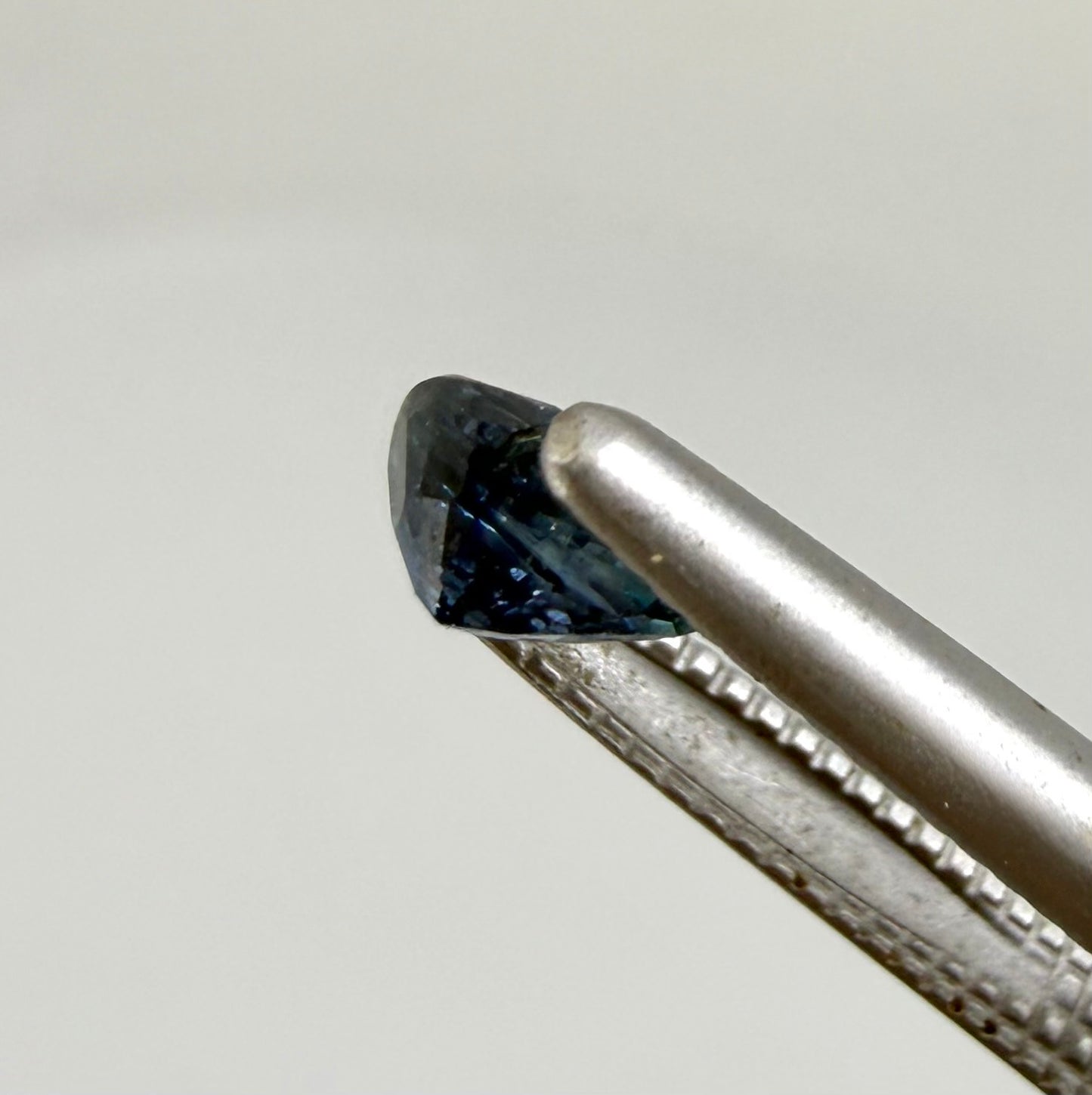 Pear teal blue sapphire from Bangkaja, Thailand with blue-green tones and natural color zoning.