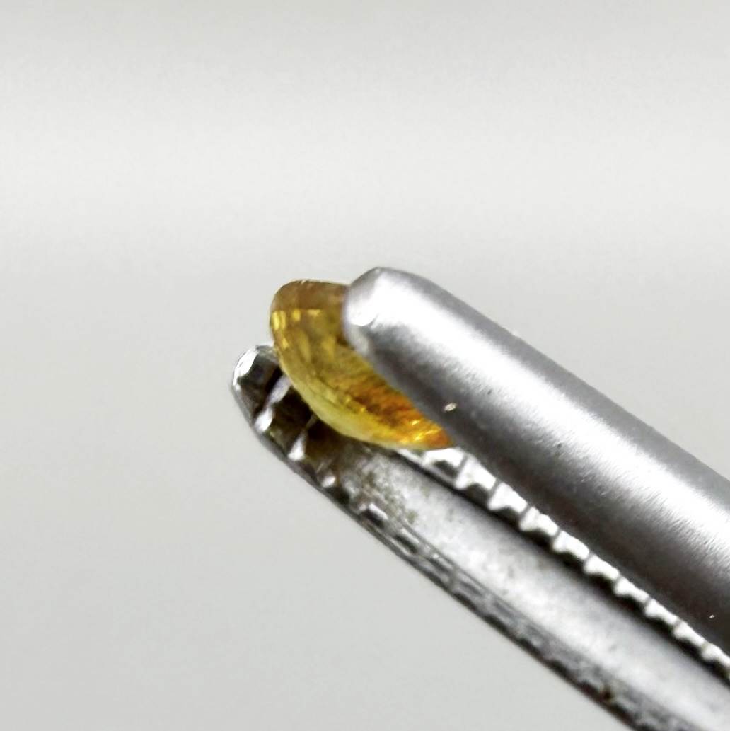 Round golden yellow sapphire from Bangkaja, Thailand with warm natural color and lively brilliance.