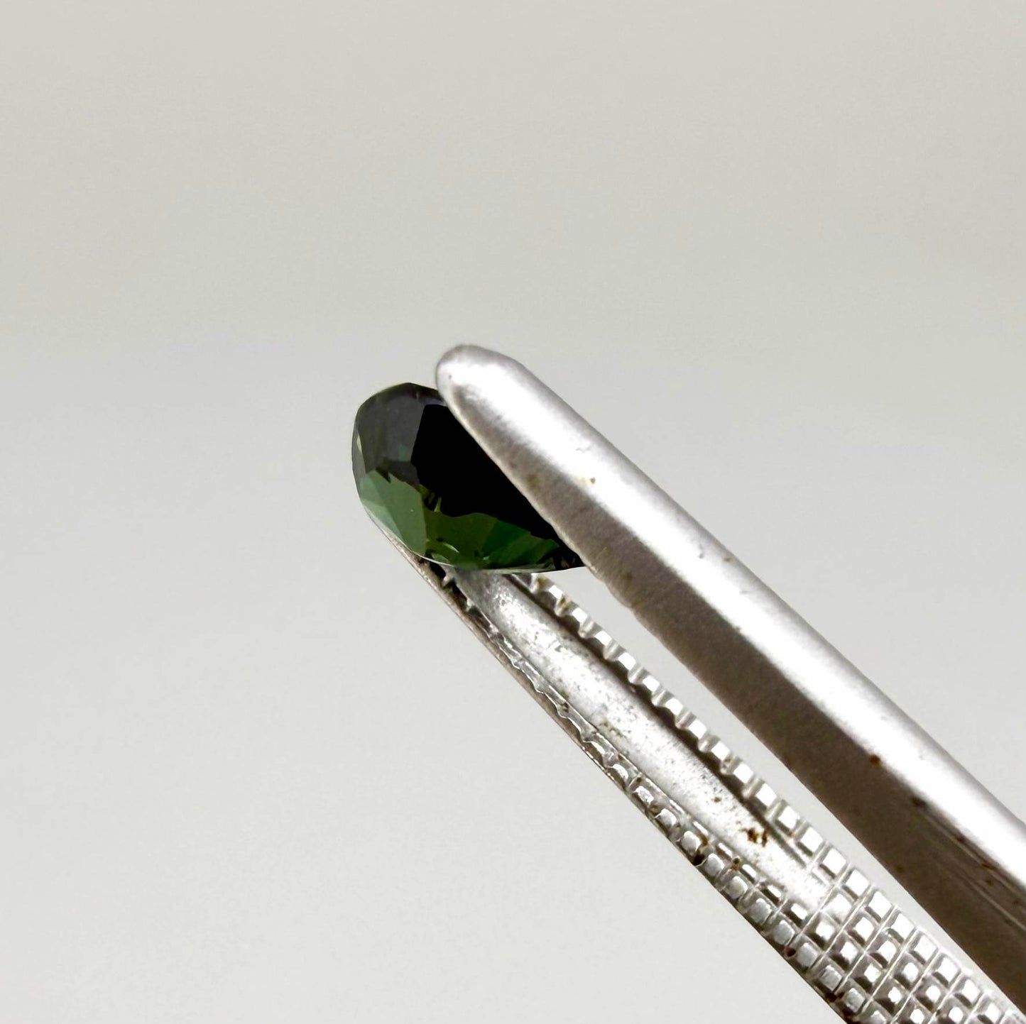 Deep teal blue-green Laos sapphire pear weighing 0.45 ct, heated and eye-clean.