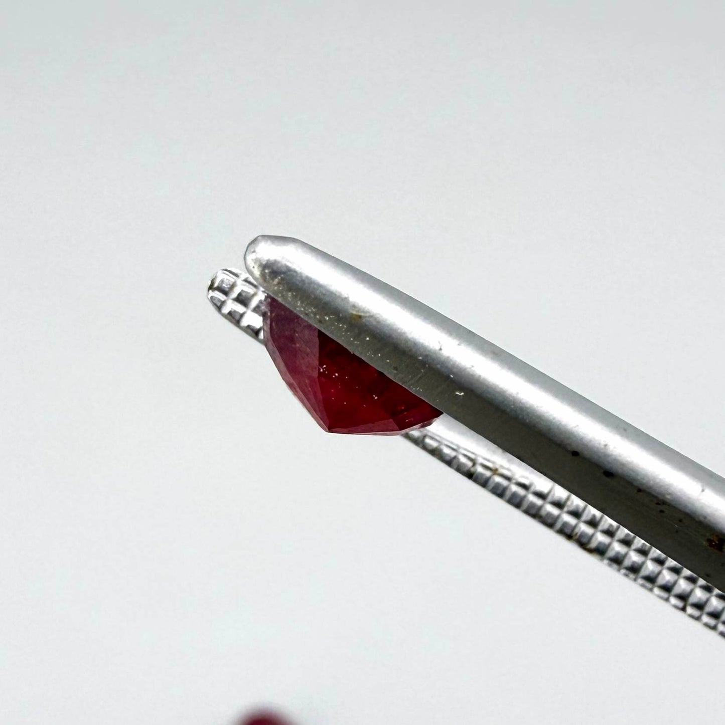 Natural Mozambique ruby pair in round cut, 2.20 ct total weight, enhanced and precisely matched.