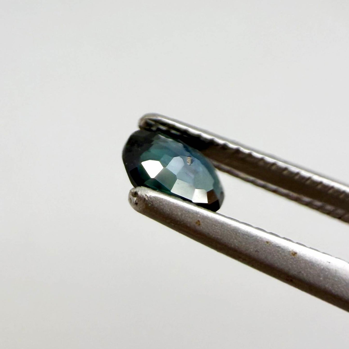 0.28 ct natural heated teal Laos sapphire with oval faceted cut and eye-clean clarity
