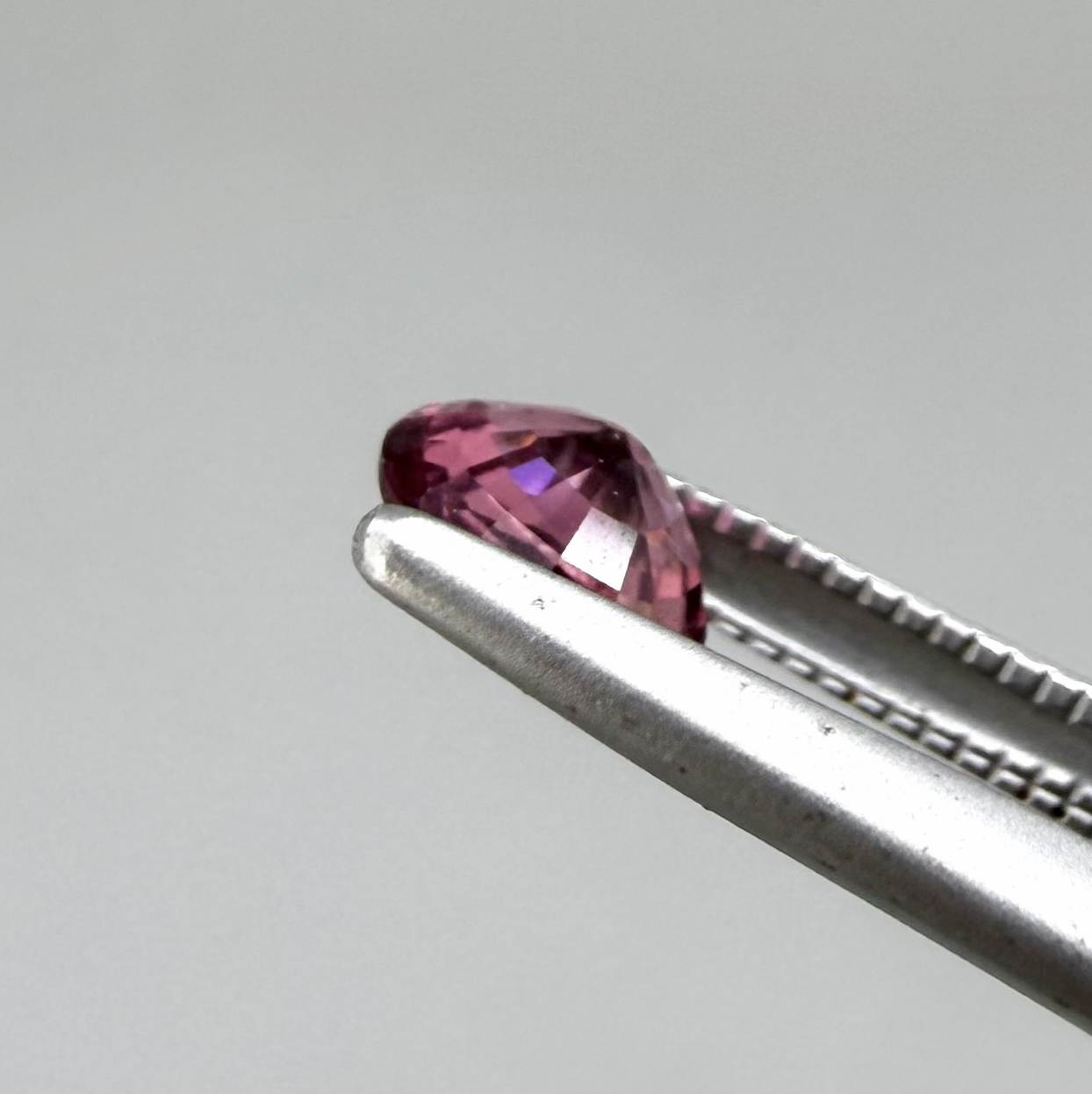 Natural untreated vivid raspberry pink tourmaline, 0.56 ct round cut from Nigeria with vivid raspberry pink colour, eye-clean clarity and exceptional brilliance.