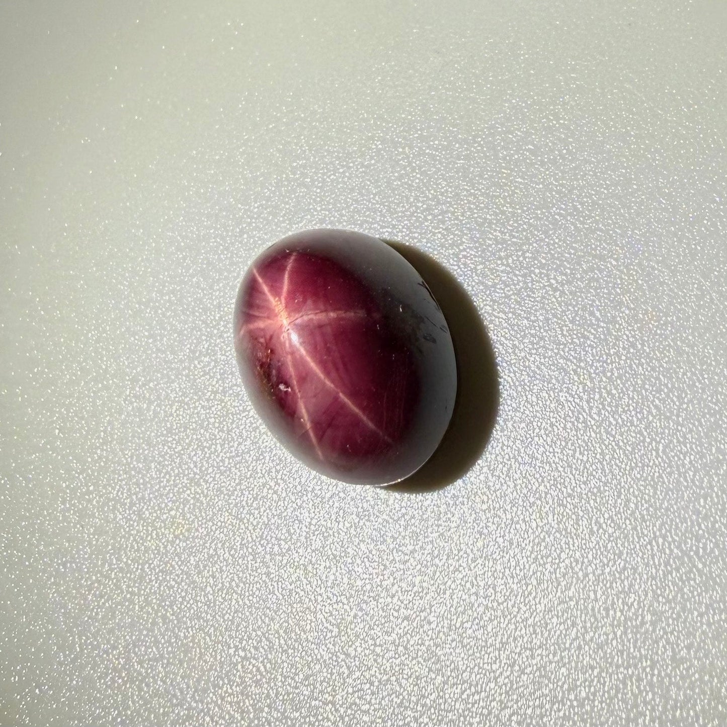19 ct natural Wine-Red Star Ruby cabochon from Mozambique with soft star effect and polished dome.