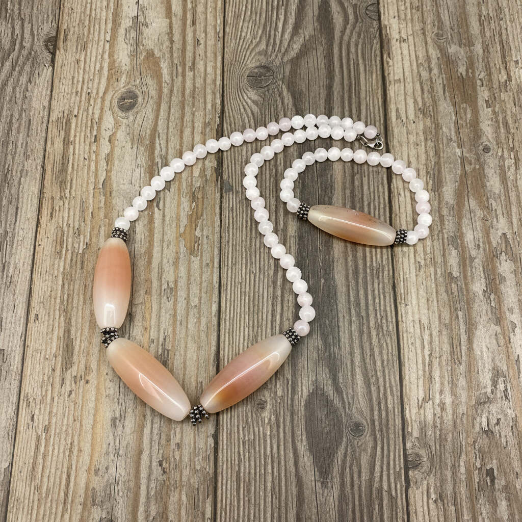 Rose quartz necklace and bracelet set, featuring soft pink beads with peach-toned accent stones, necklace 46 cm / 18.1 in, bracelet 17 cm / 6.7 in.