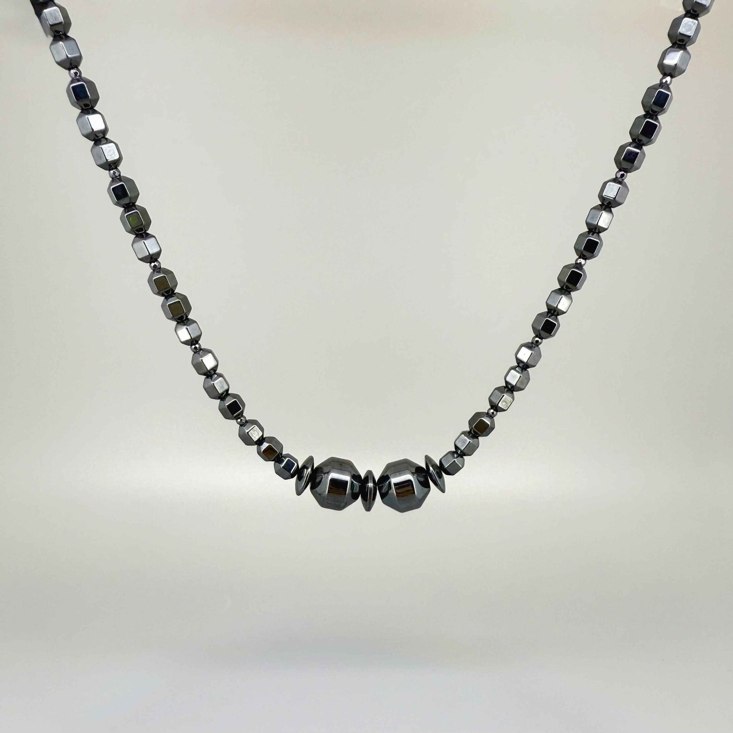 Hematite beaded necklace, 45 cm / 17.7 in long, with polished metallic grey stones and larger statement center beads.
