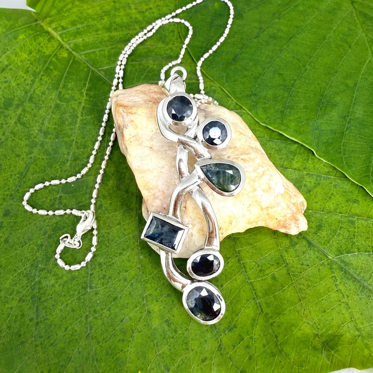 Handmade pendant with 14.68 ct natural blue sapphires set in white-gold-plated sterling silver.
