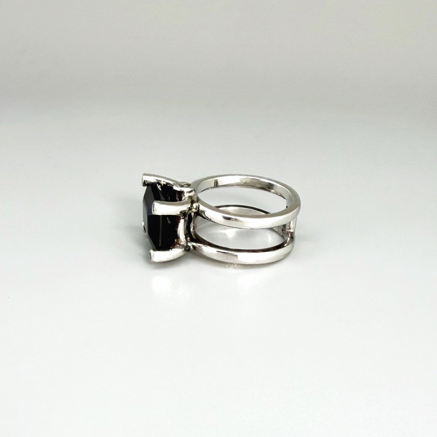 Emerald-cut sapphire ring in white gold plated sterling silver, featuring a natural deep blue gemstone in a bold and elegant solitaire design.