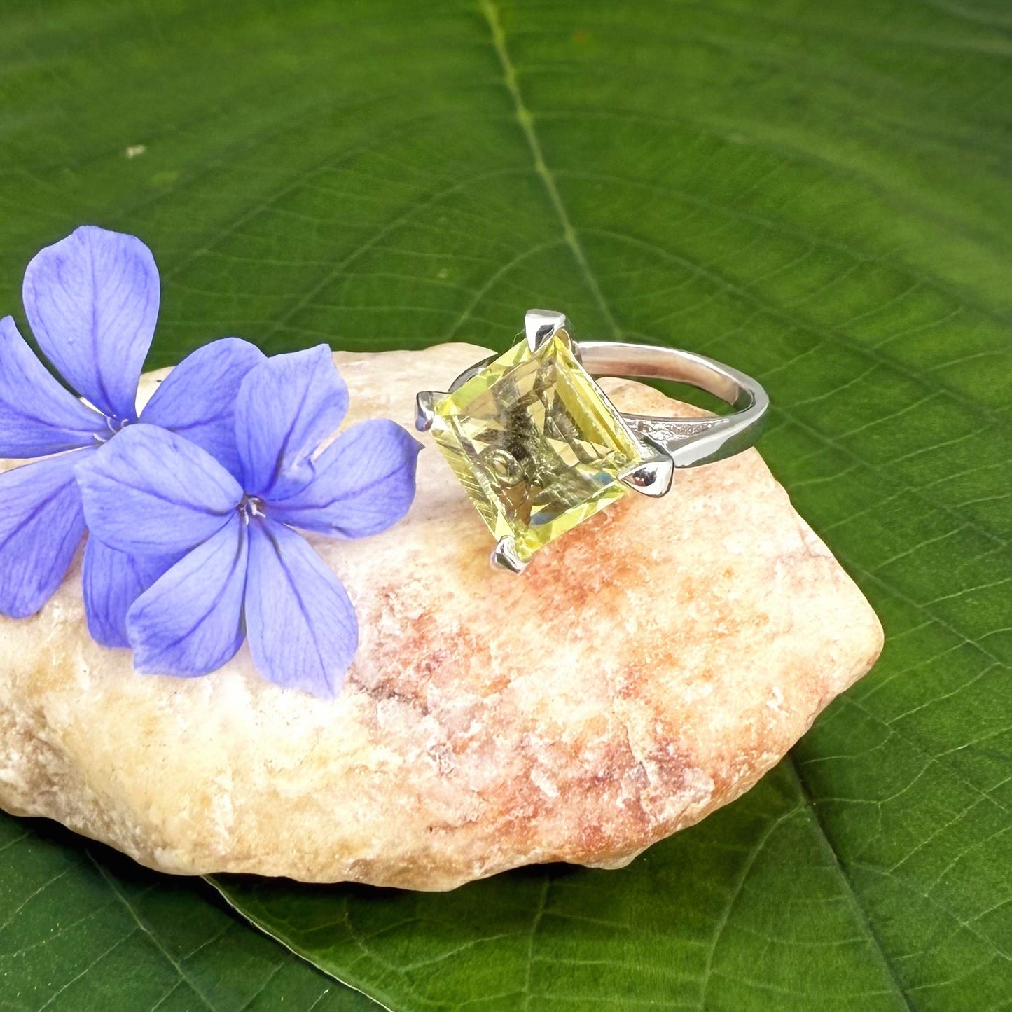 Lemon quartz solitaire ring in white gold plated sterling silver, featuring a rectangular faceted yellow gemstone, elegant and timeless design.