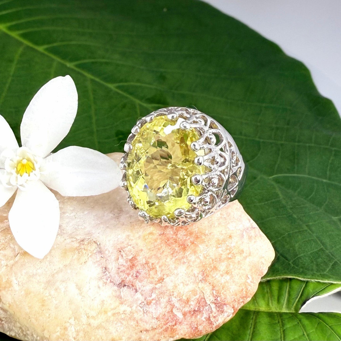 Statement ring with oval lemon quartz set in white gold plated sterling silver featuring intricate silver details and radiant yellow tones.