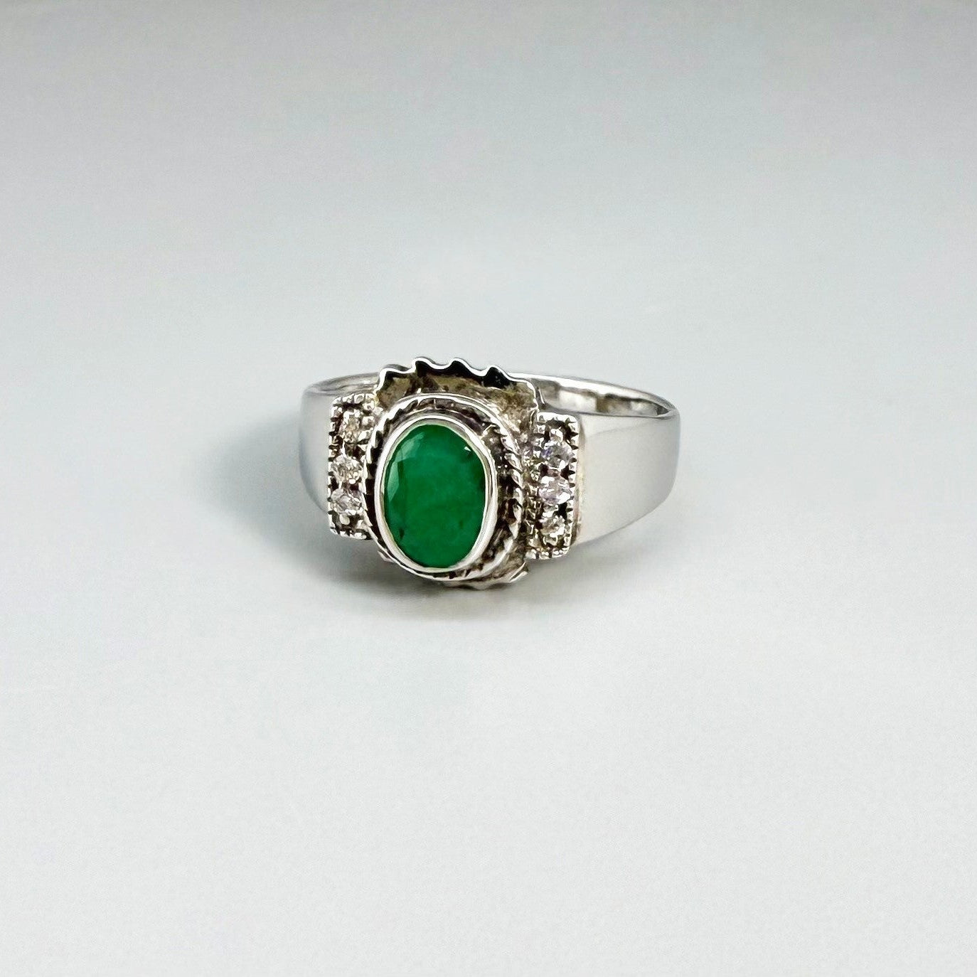 Green quartz cabochon ring in white gold plated sterling silver, featuring an oval vivid green gemstone with soft translucent glow and refined silver design.
