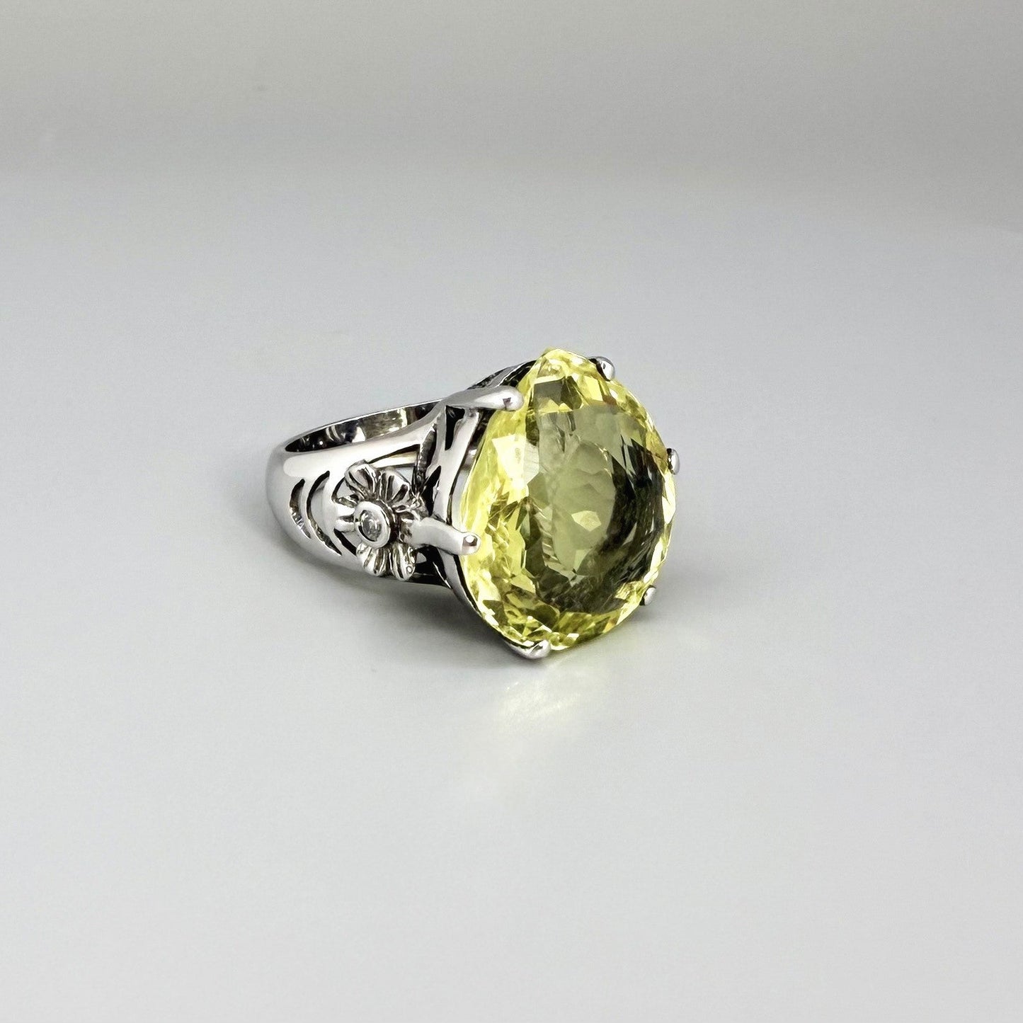 White gold plated sterling silver ring featuring an oval lemon quartz gemstone, bright yellow tones and elegant handcrafted design.