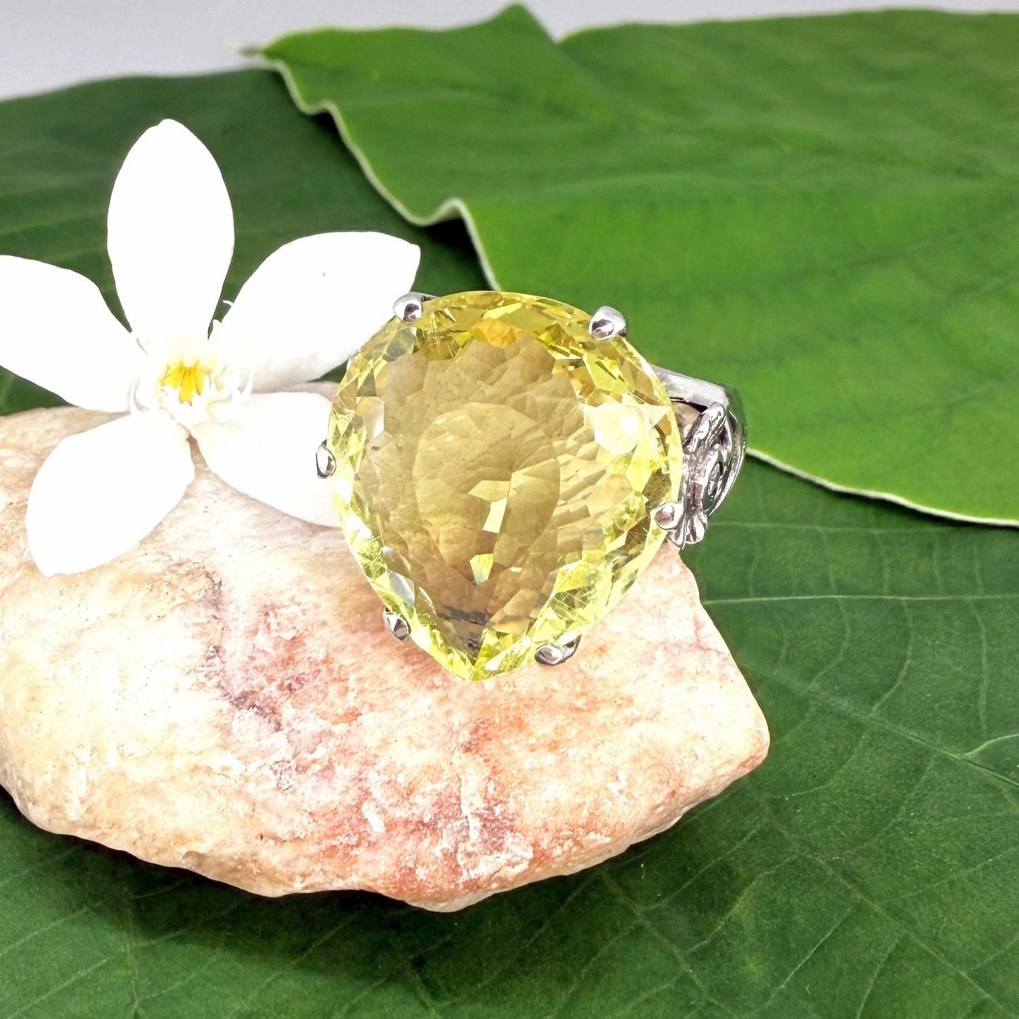 White gold plated sterling silver ring featuring an oval lemon quartz gemstone, bright yellow tones and elegant handcrafted design.