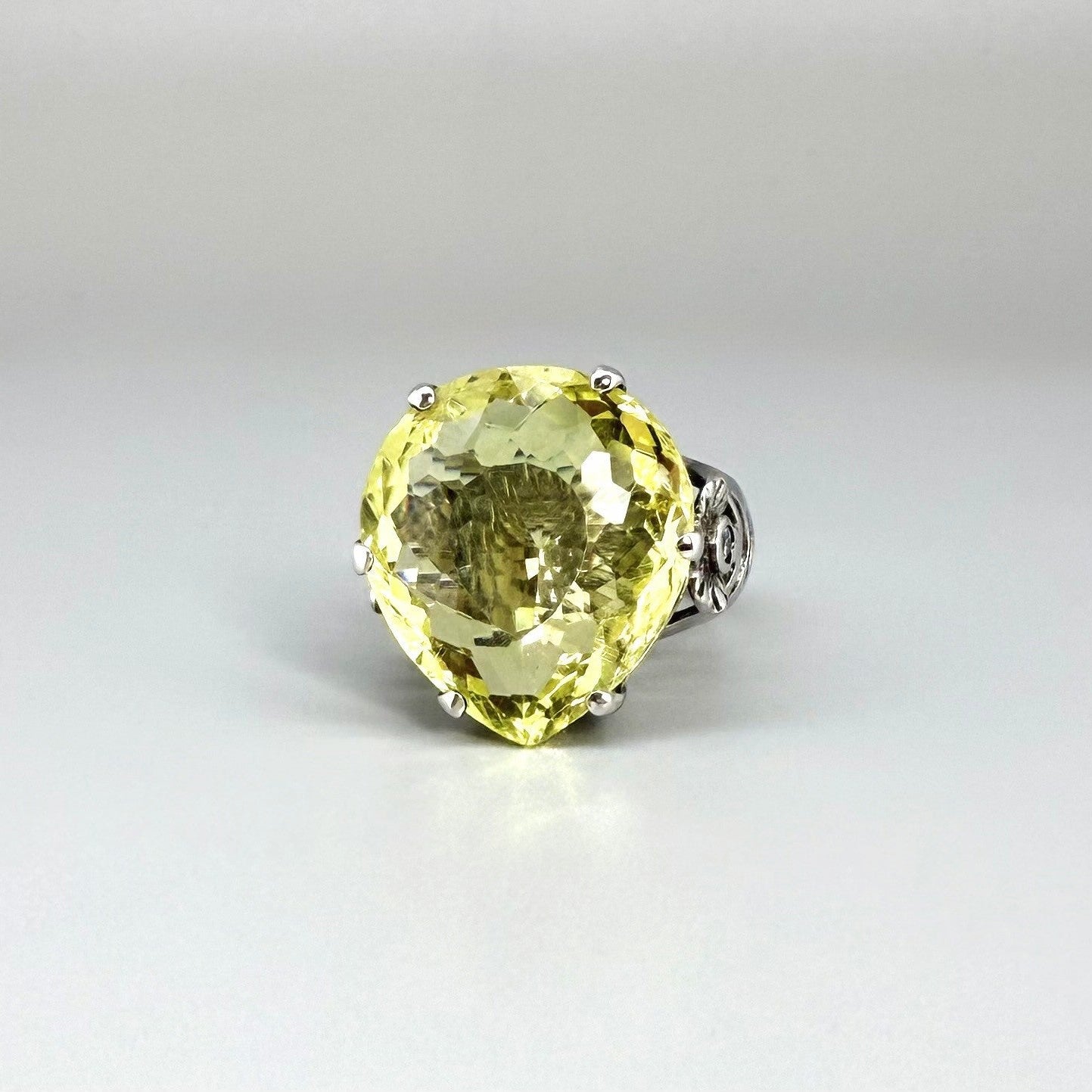 White gold plated sterling silver ring featuring an oval lemon quartz gemstone, bright yellow tones and elegant handcrafted design.