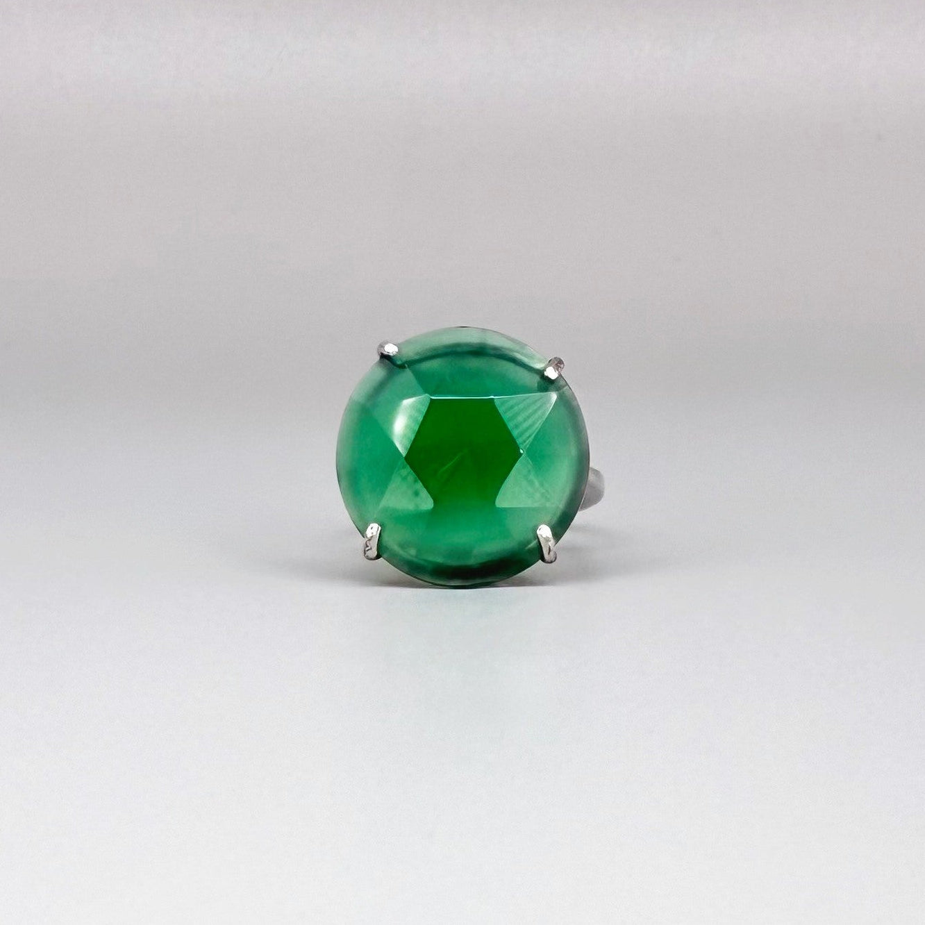 White gold plated sterling silver ring with large faceted green chalcedony gemstone, elegant solitaire design with rich natural color.