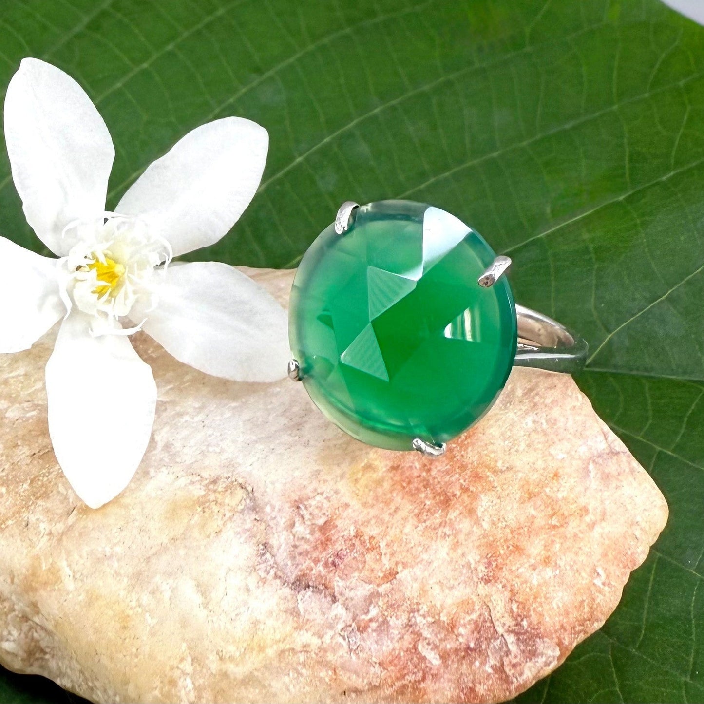 White gold plated sterling silver ring with large faceted green chalcedony gemstone, elegant solitaire design with rich natural color.