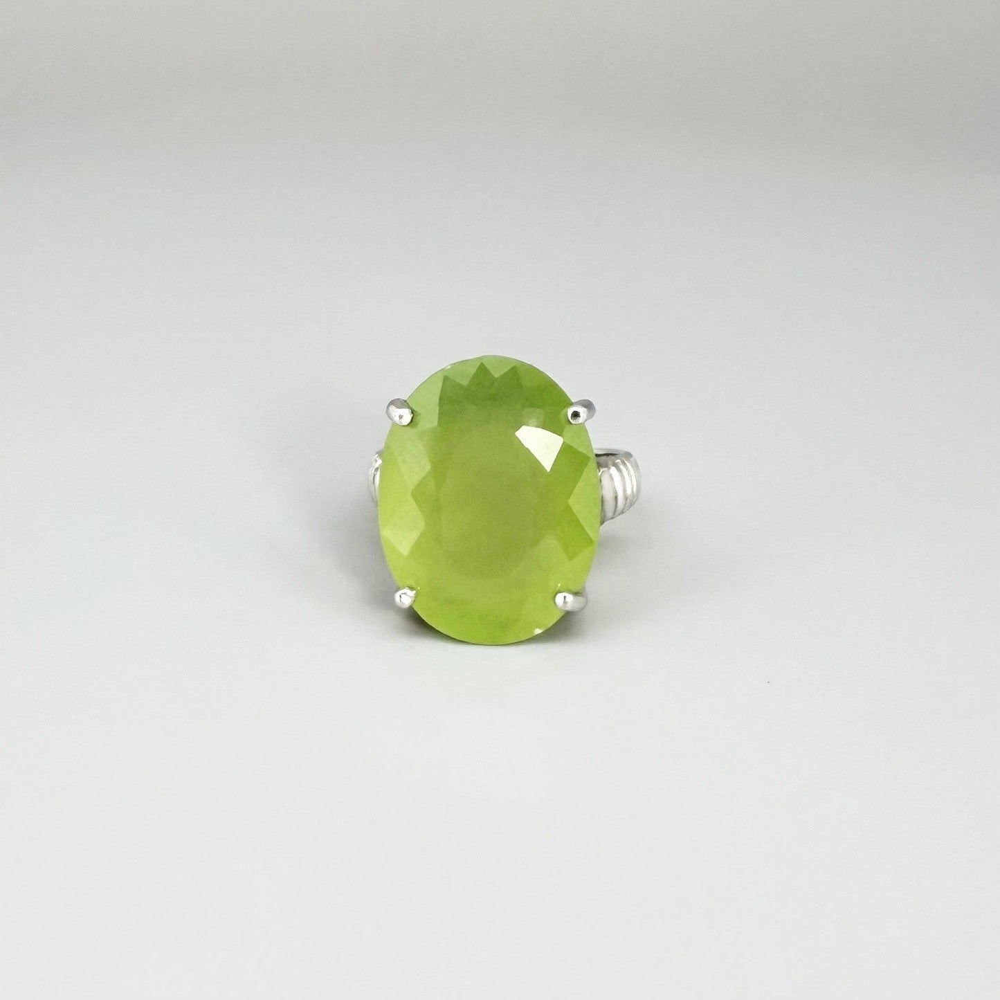 White gold plated sterling silver ring featuring an oval green quartz gemstone, elegant solitaire design with soft natural color.