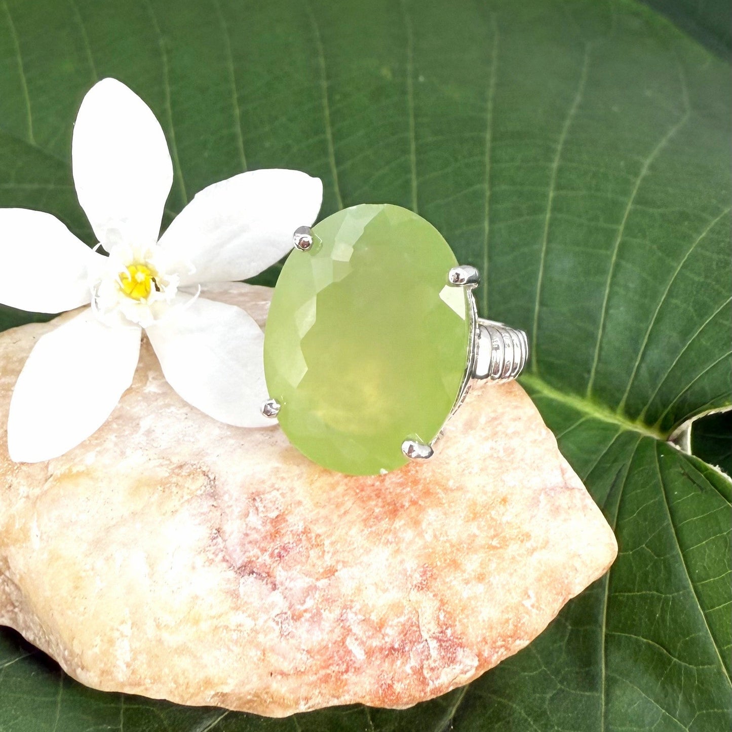 White gold plated sterling silver ring featuring an oval green quartz gemstone, elegant solitaire design with soft natural color.
