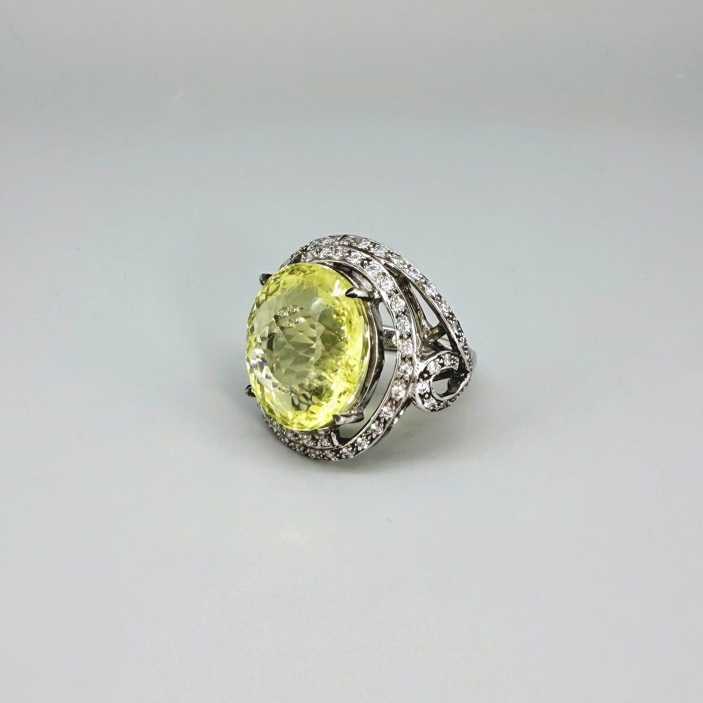 Lemon quartz and CZ ring in white gold plated sterling silver, featuring a faceted yellow gemstone framed by clear cubic zirconia, elegant and radiant design.