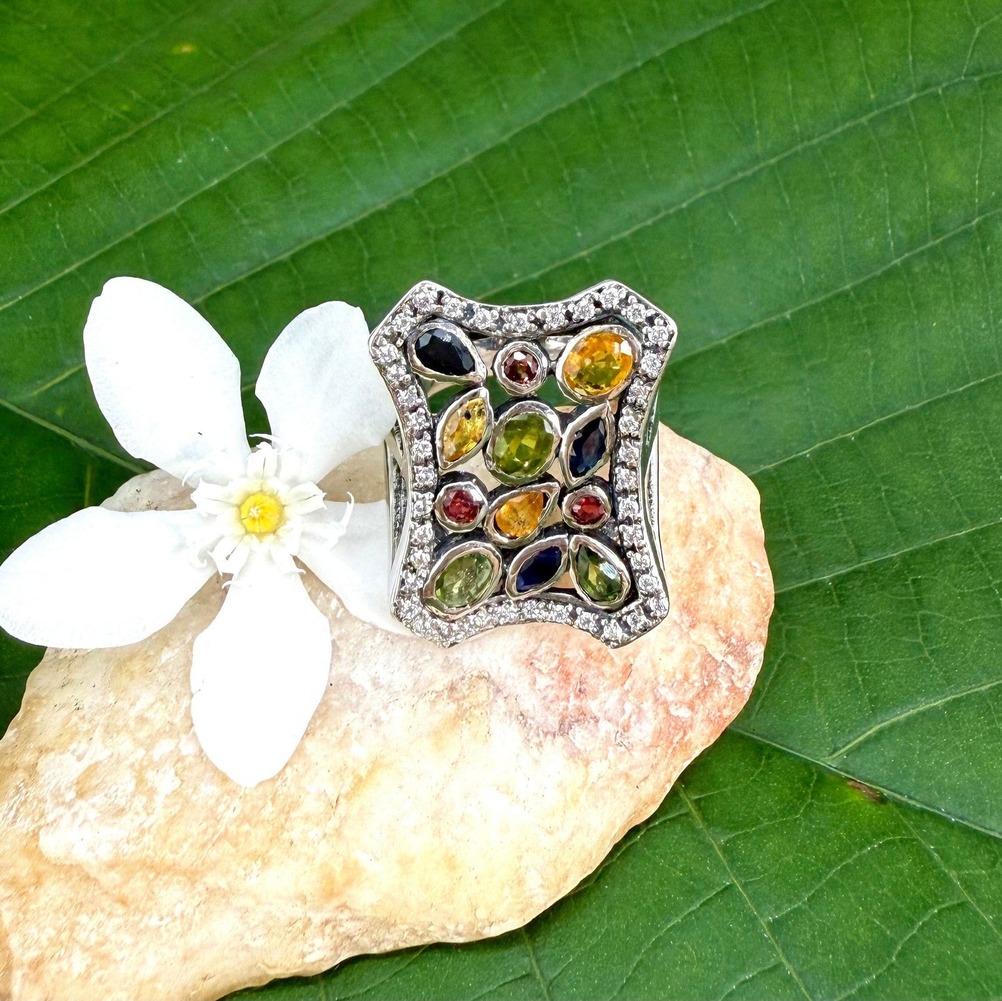 Multigemstone ring in white gold plated sterling silver, featuring sapphires, topaz, tourmalines and spinels in geometric design, colorful and elegant.