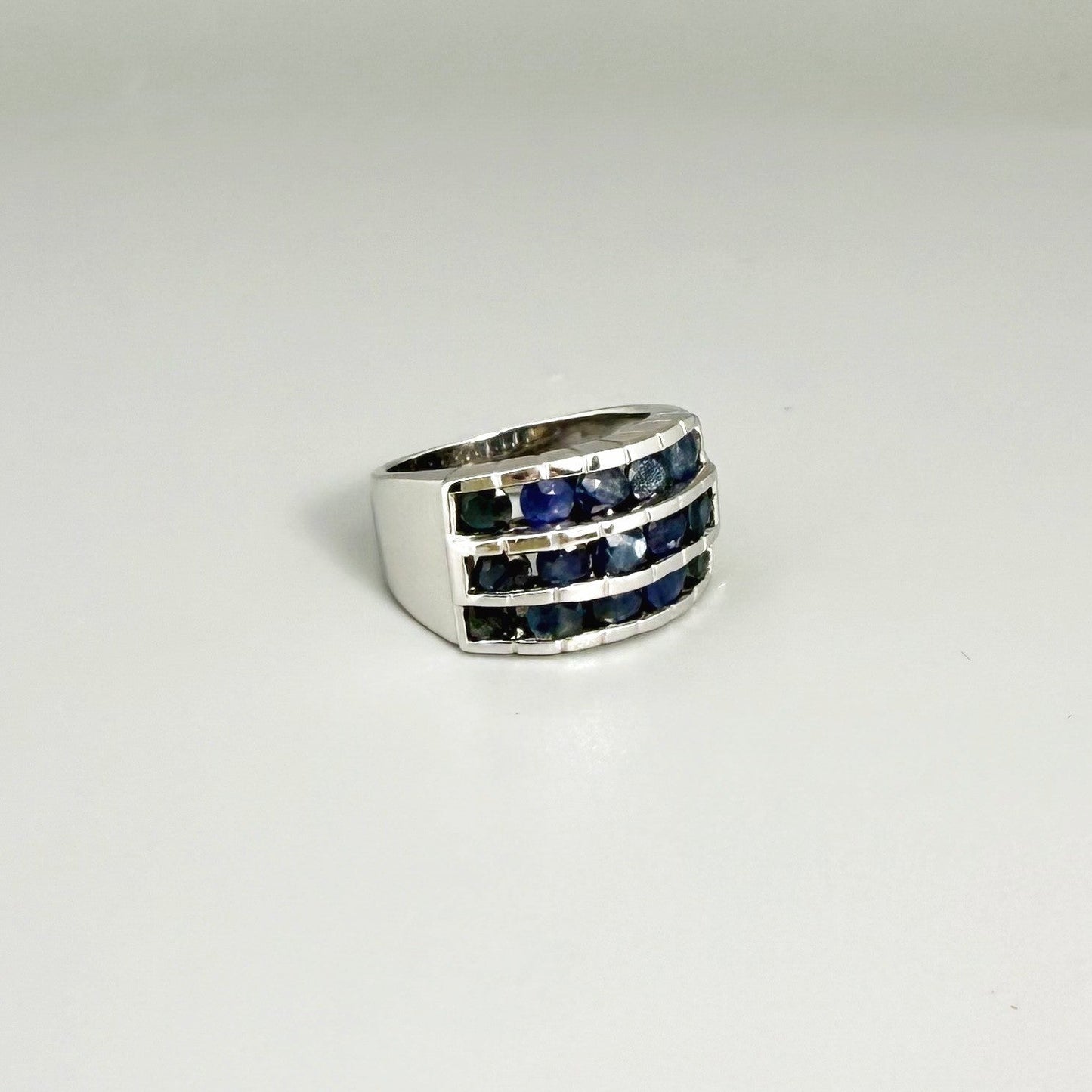 Sapphire band ring in white gold plated sterling silver, featuring three rows of natural deep blue gemstones, elegant and timeless design.