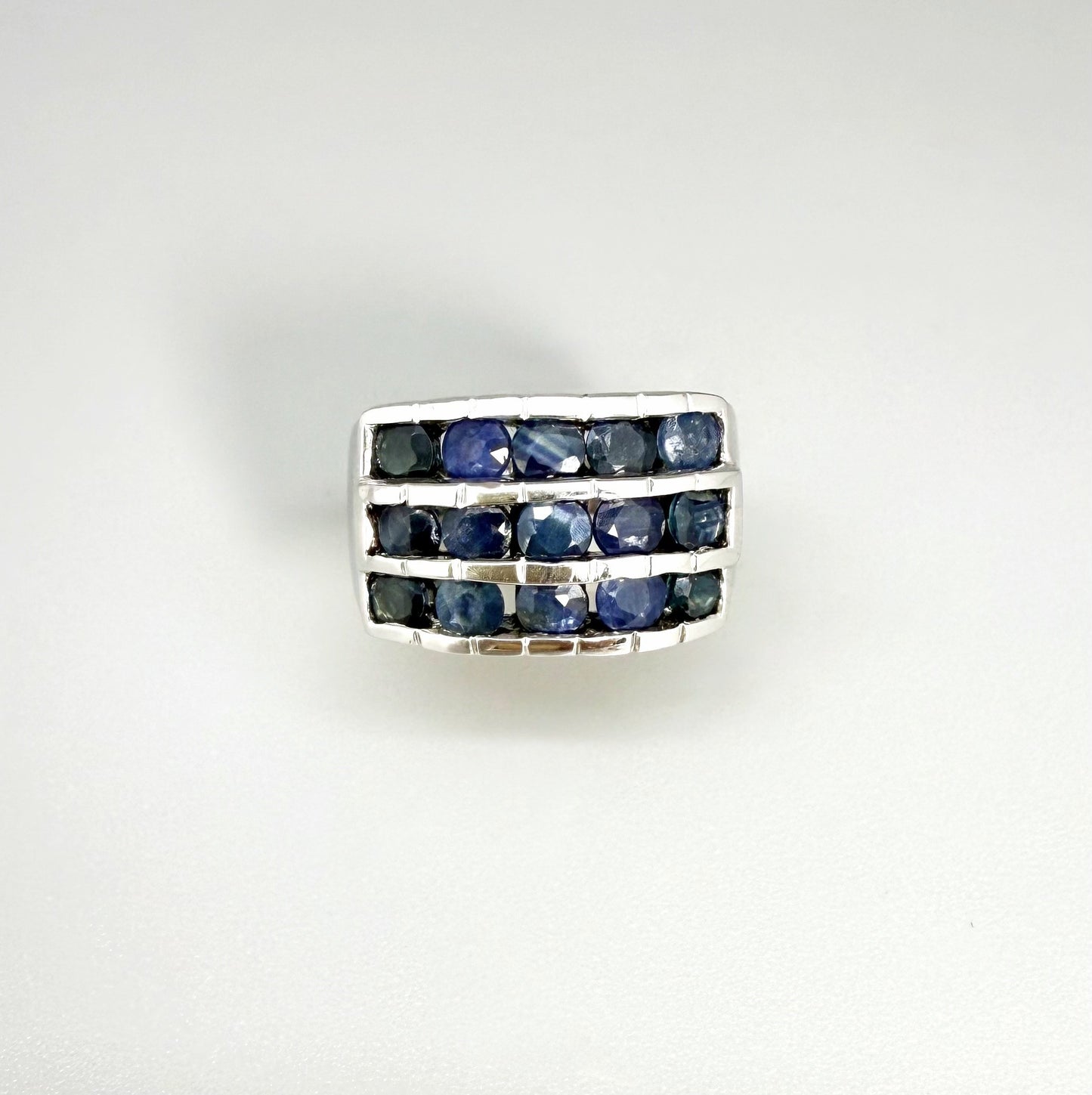 Sapphire band ring in white gold plated sterling silver, featuring three rows of natural deep blue gemstones, elegant and timeless design.