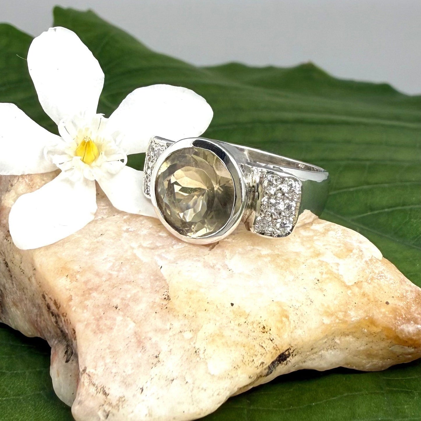 Citrine and CZ ring in white gold plated sterling silver, featuring a faceted golden gemstone with sparkling accents along the band, elegant and radiant design.