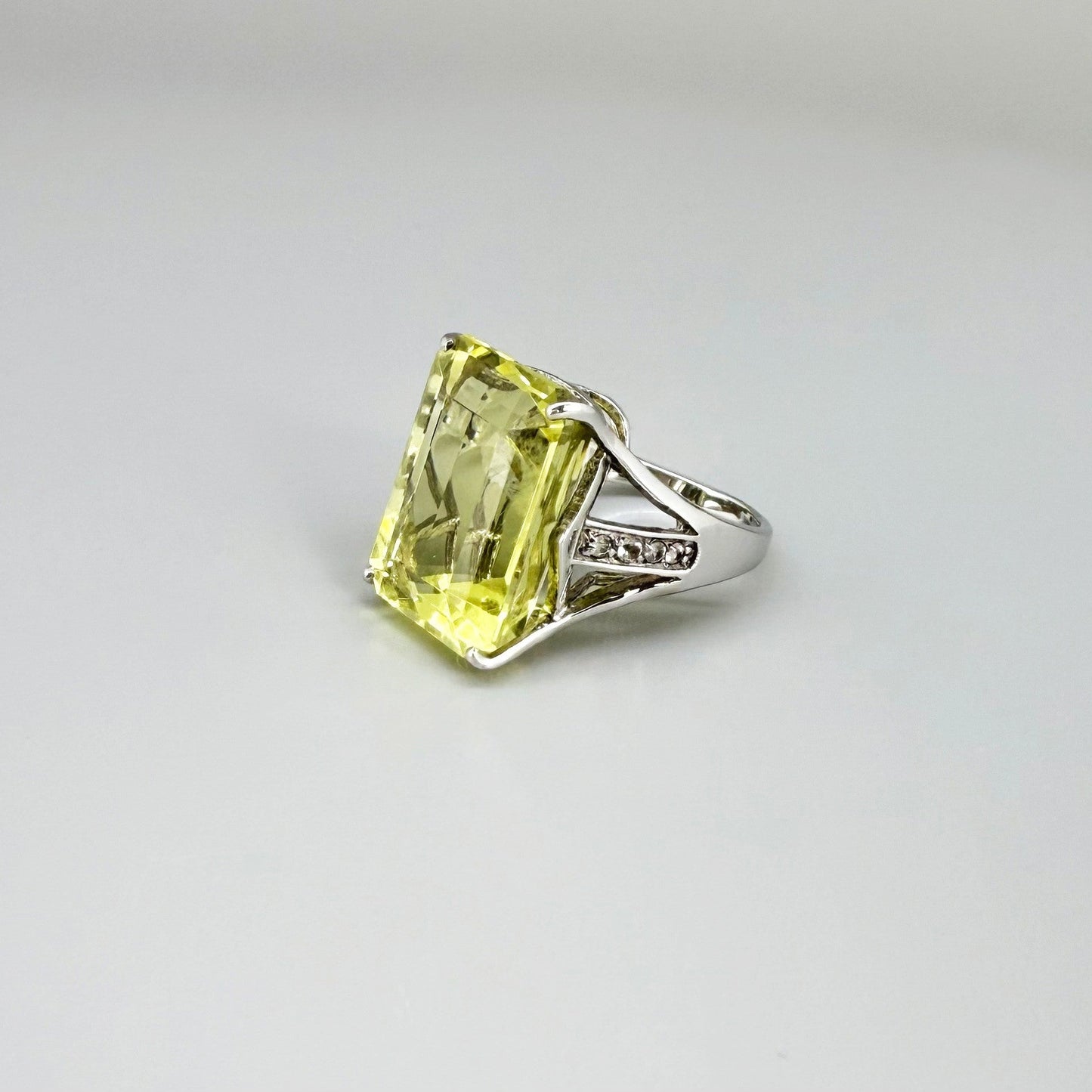 Chrysoprase and CZ ring in white gold plated sterling silver, featuring a rectangular bright green gemstone with clear cubic zirconia side accents, elegant and modern design.