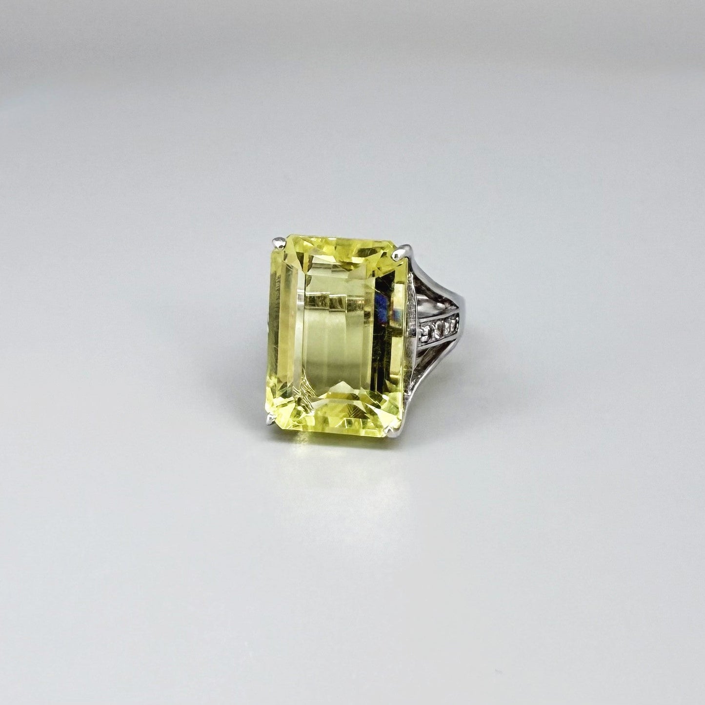 Chrysoprase and CZ ring in white gold plated sterling silver, featuring a rectangular bright green gemstone with clear cubic zirconia side accents, elegant and modern design.