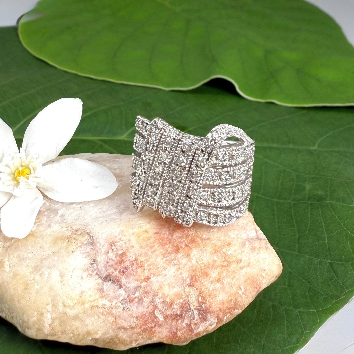 Wide band cubic zirconia ring in white gold plated sterling silver, featuring clear brilliant stones for a radiant, timeless sparkle.