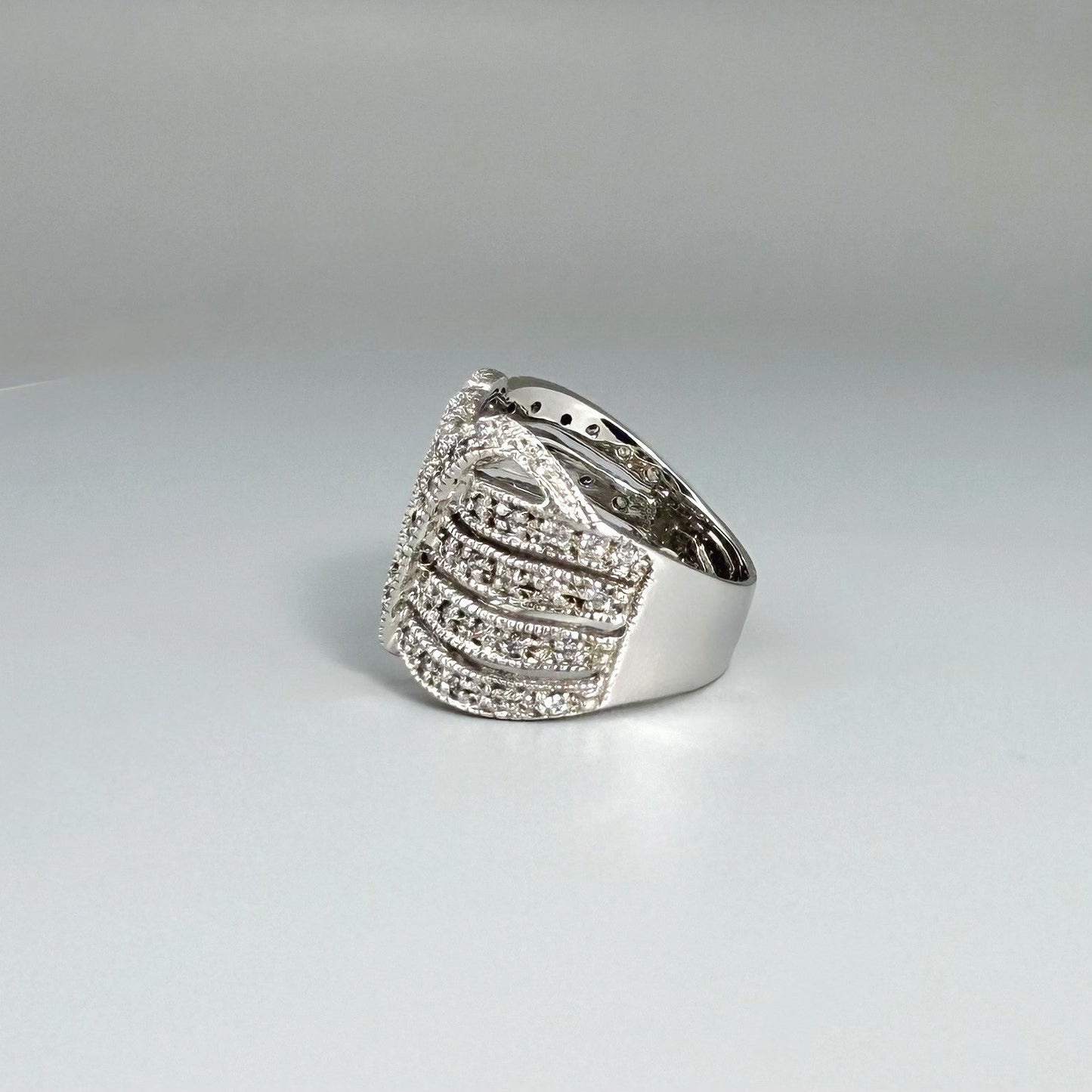 Wide band cubic zirconia ring in white gold plated sterling silver, featuring clear brilliant stones for a radiant, timeless sparkle.
