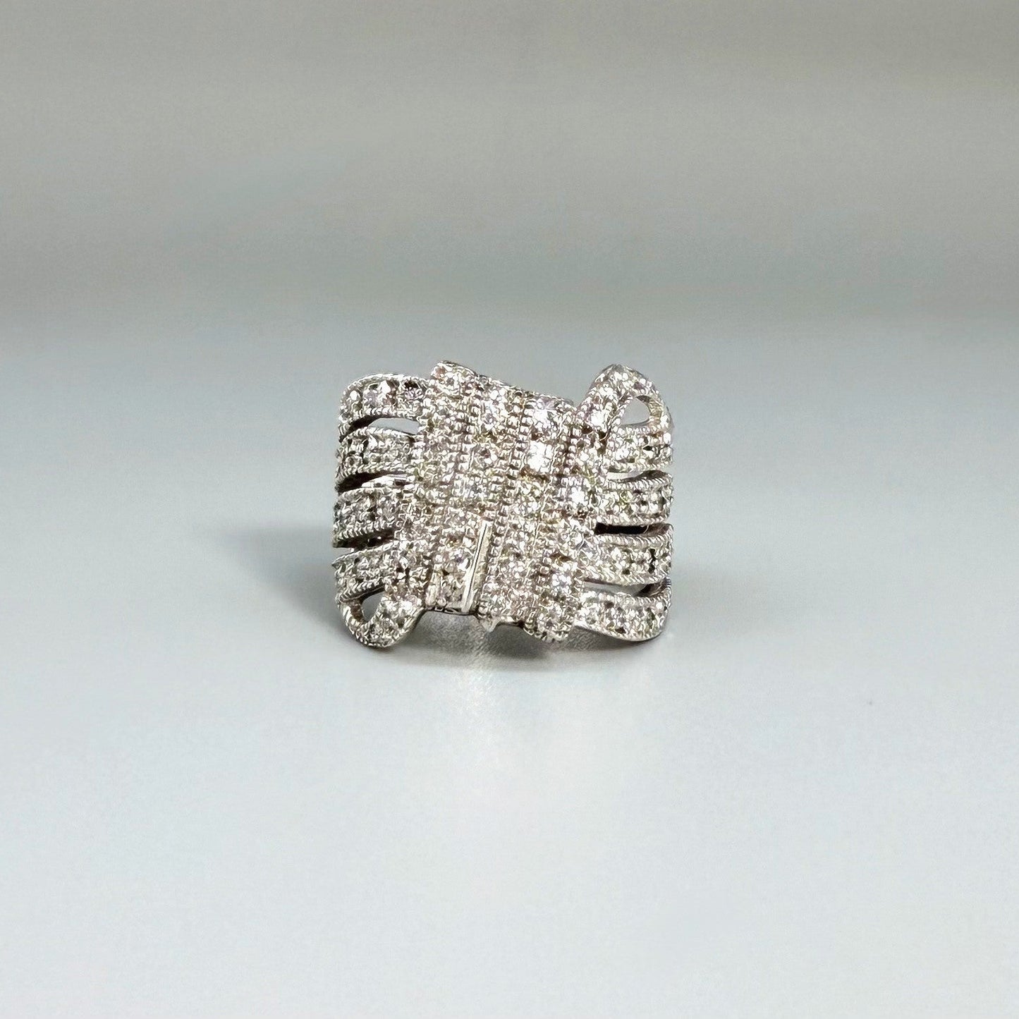 Wide band cubic zirconia ring in white gold plated sterling silver, featuring clear brilliant stones for a radiant, timeless sparkle.