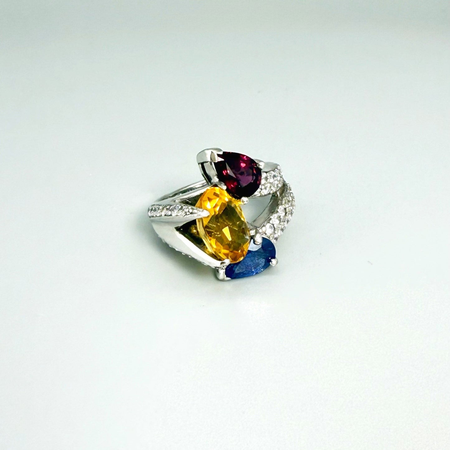 Sapphire, citrine, and rhodolite ring in white gold plated sterling silver, framed with sparkling cubic zirconia, featuring vivid natural gemstones in elegant design.