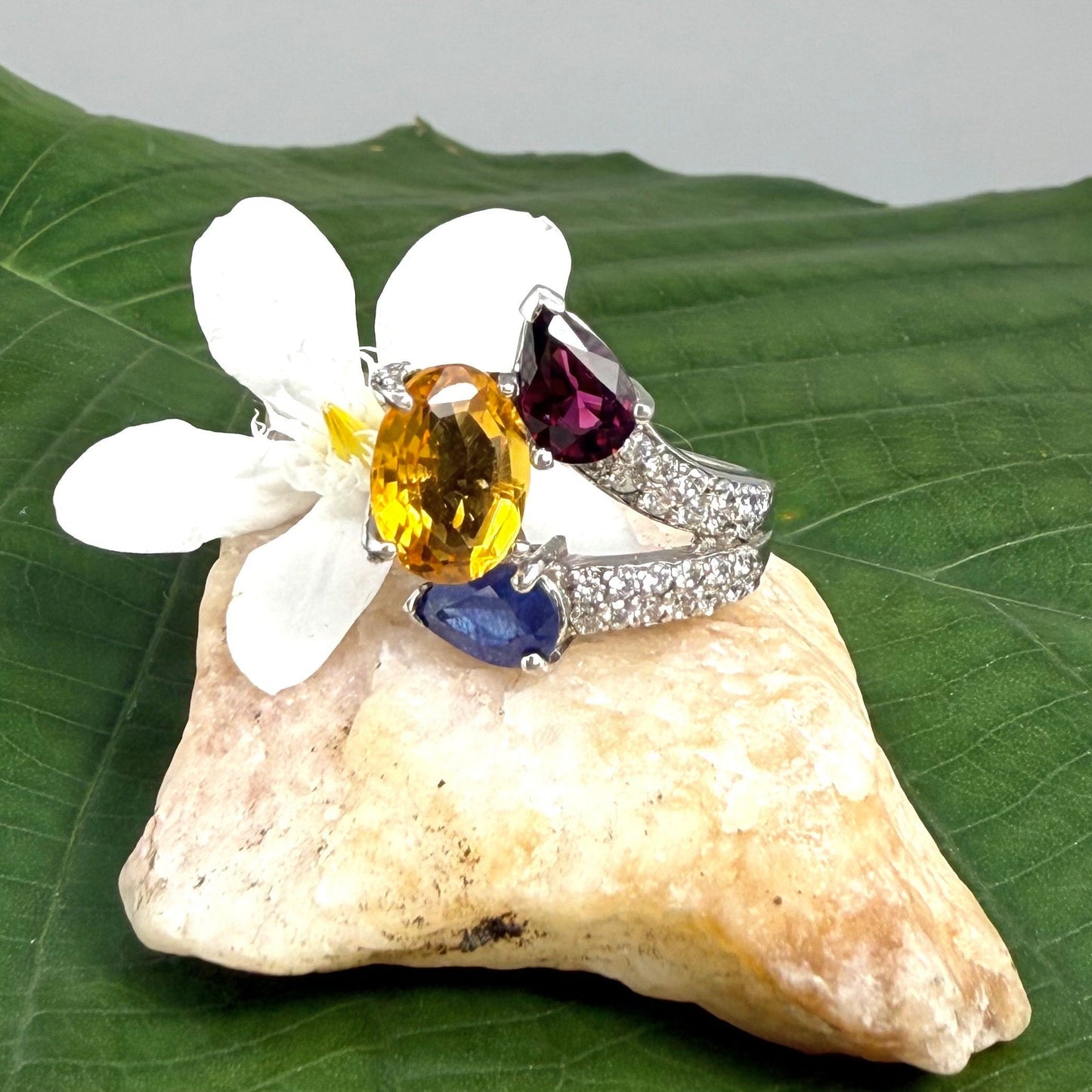 Sapphire, citrine, and rhodolite ring in white gold plated sterling silver, framed with sparkling cubic zirconia, featuring vivid natural gemstones in elegant design.