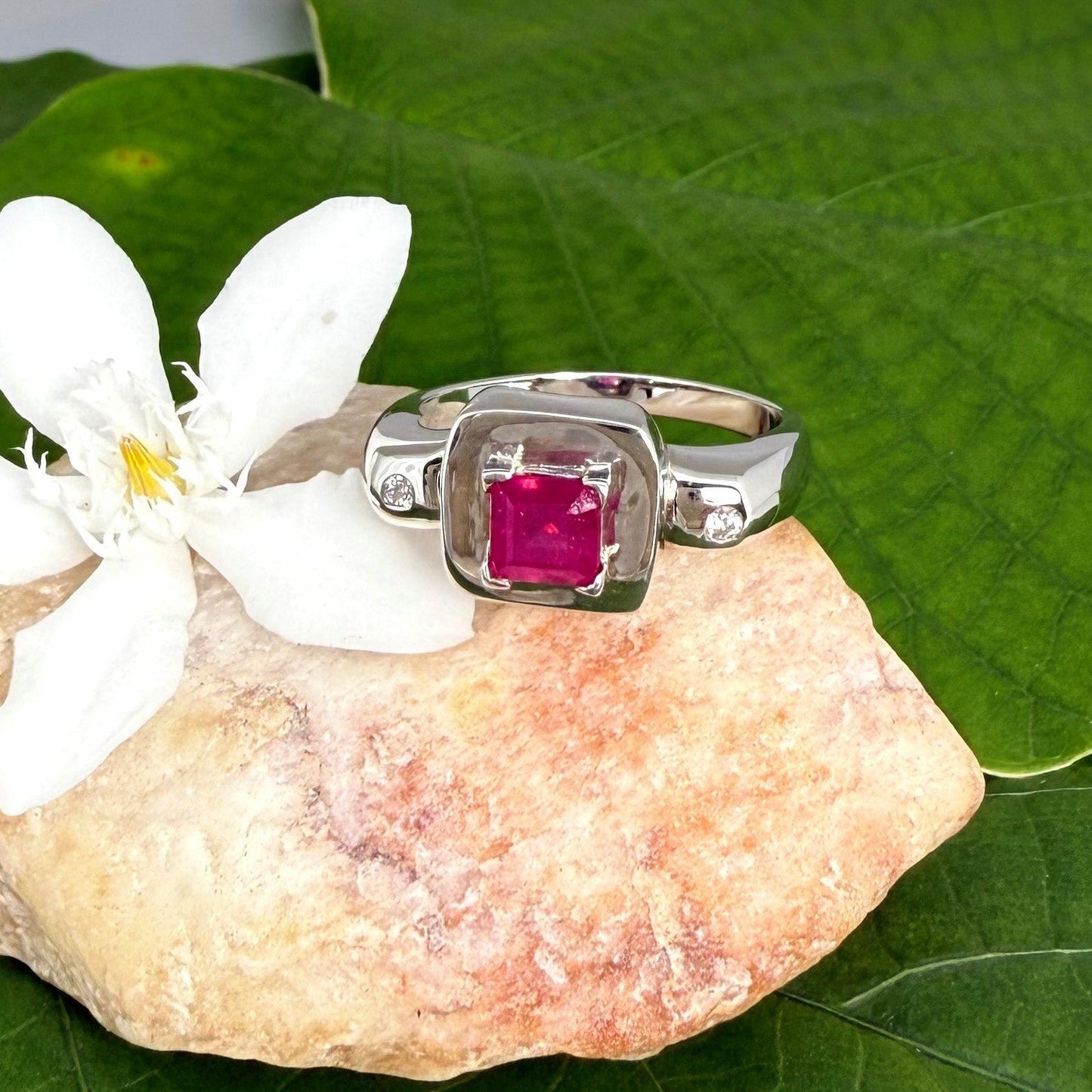 Ruby and CZ ring in white gold plated sterling silver, featuring a vivid red natural ruby framed by clear cubic zirconia, elegant and classic design.