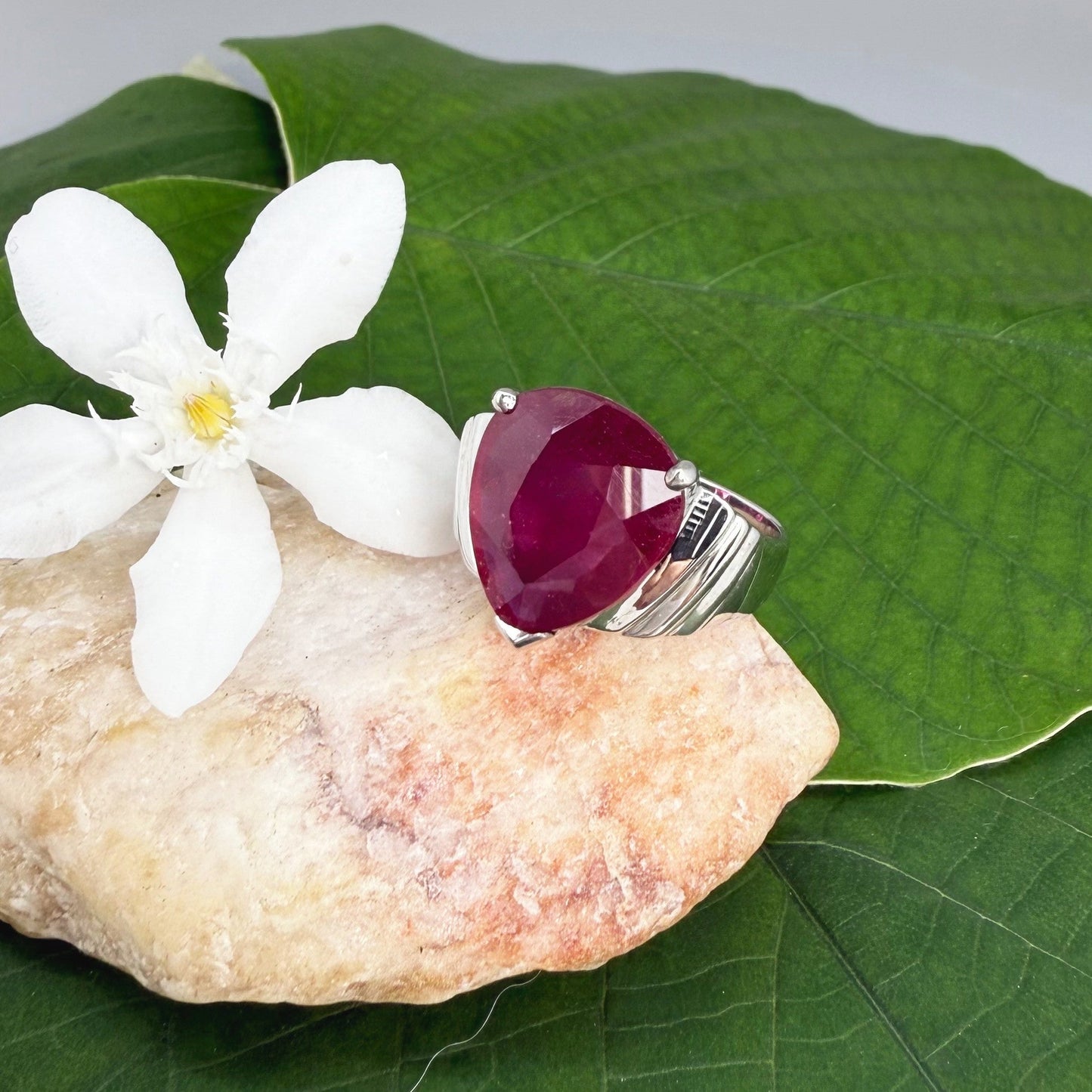 Ruby solitaire ring in white gold plated sterling silver, featuring a natural deep red gemstone, elegant and timeless design.